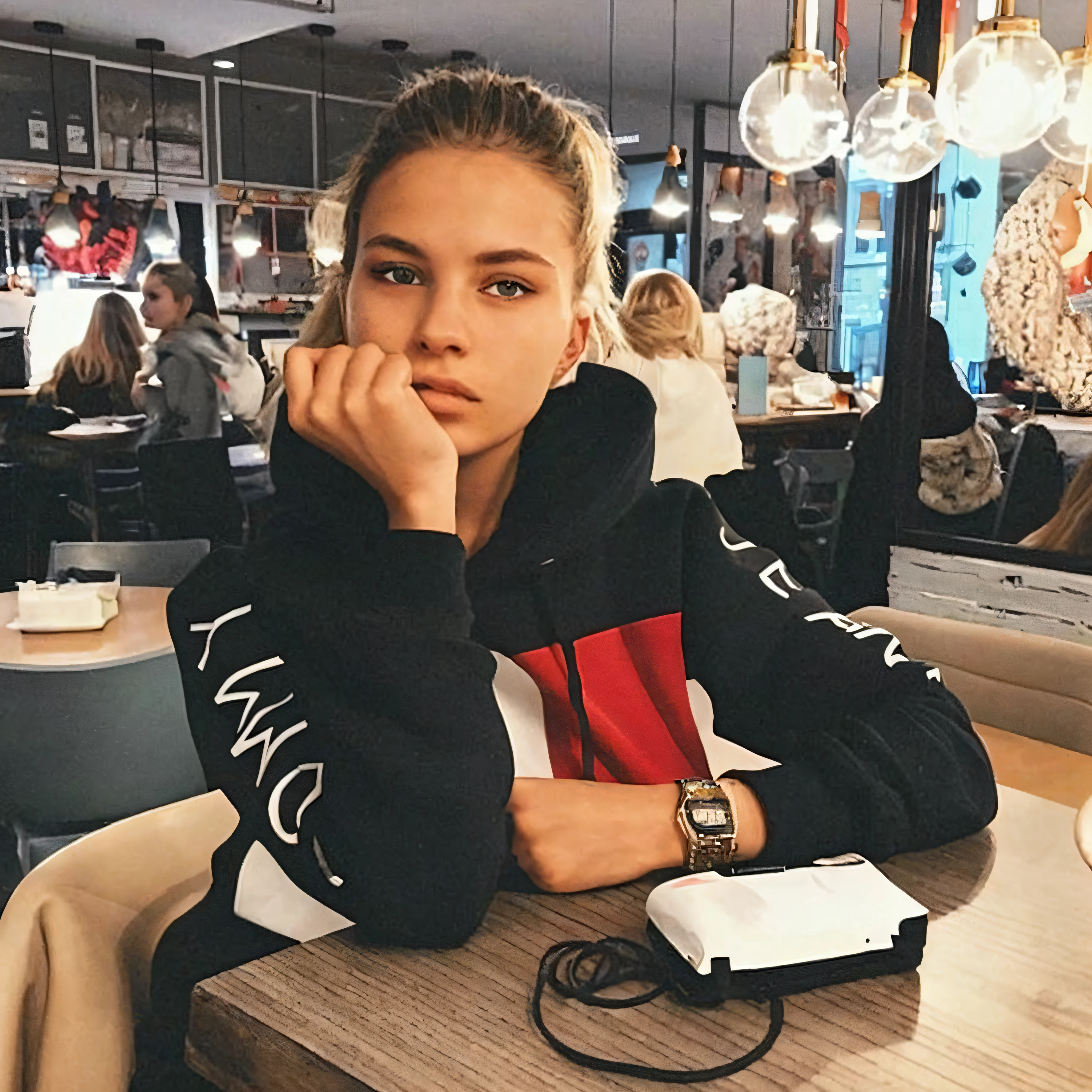 araffed woman sitting at a table with a cell phone in her hand, girl wearing hoodie, attractive girl, style of julia razumova, beautiful model, cool looking, she is wearing streetwear, cute girl, nice face, cute woman, woman in streetwear, wearing sweatshirt, beautiful girl, gorgeous female, aleksandra waliszewska, teen girl