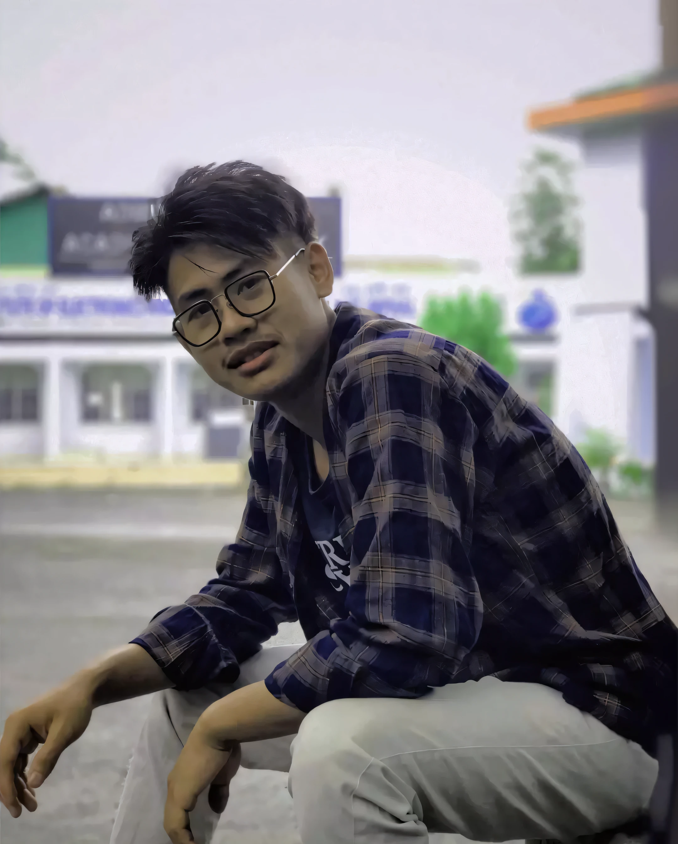 an anime boy sitting with happiness