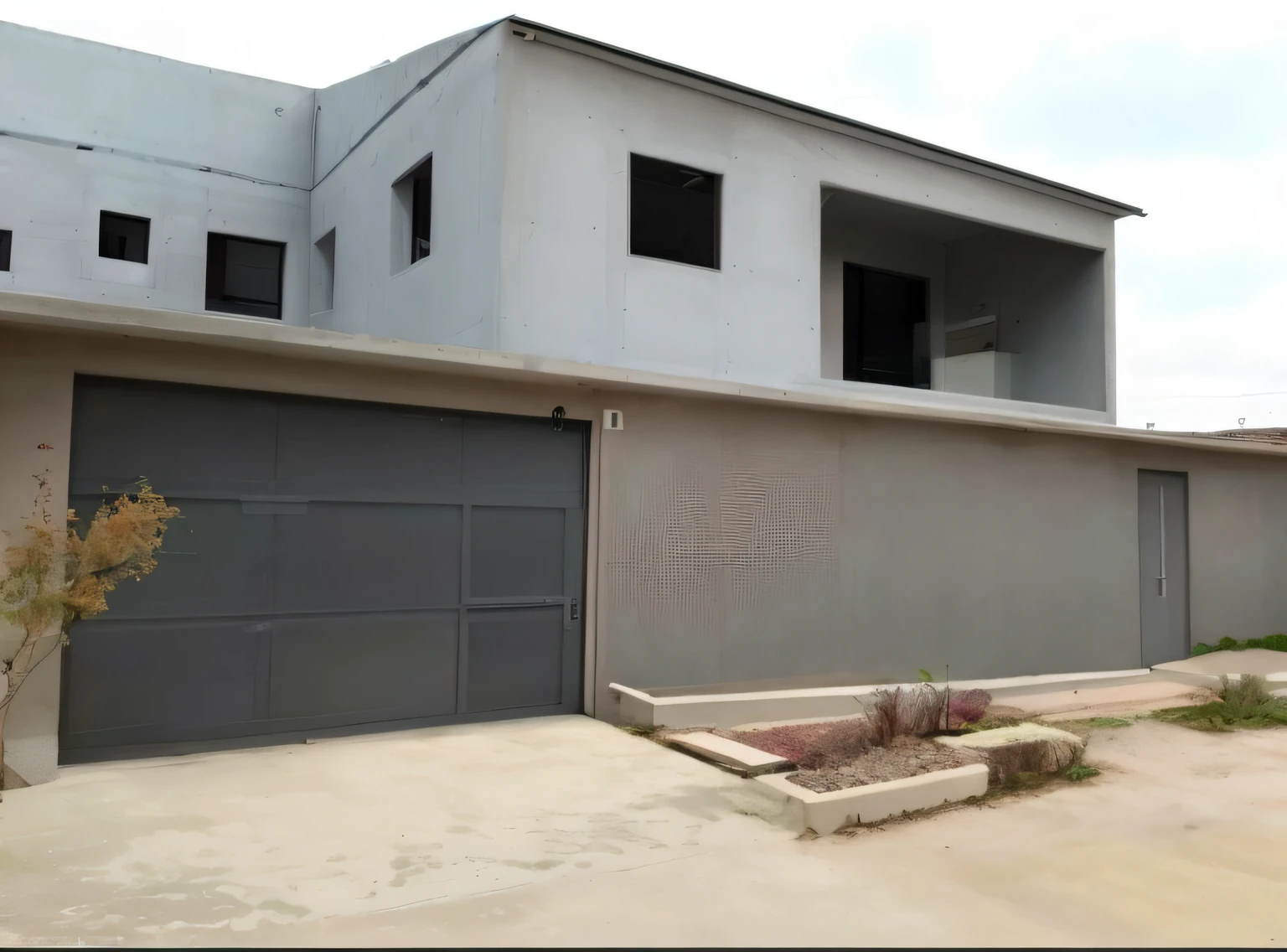 A closeup of a building with a cream color and glass in the windows. Ahead of you, Casa completa, casa de rico, fully built buildings, concrete building, Architectural finishes, imagem frontal, walls are made of dry wall, building facing, testa, Fotografia tirada em 2 0 2 0, Rough concrete walls, arhitectural shot, feito de cimento e concreto, Concrete housing and a garden