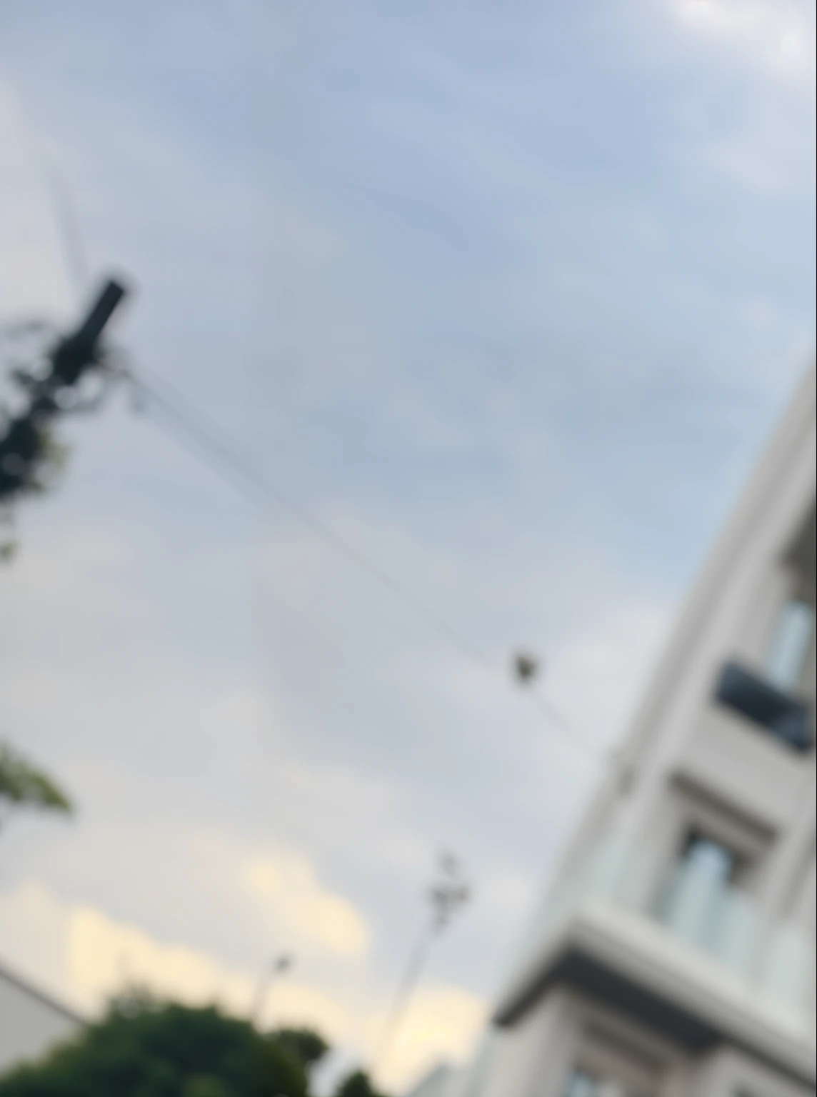 There is a man standing in front of a building with a clock on it, inspired by Ras Akyem, Dans le style de Davey Adesida, Porter un polo, belle vue, State-of-the-art experience », beau visage, high quality portrait, very very low quality picture, masterpiece work of art, Prise avec Sony Alpha 9, high quality image