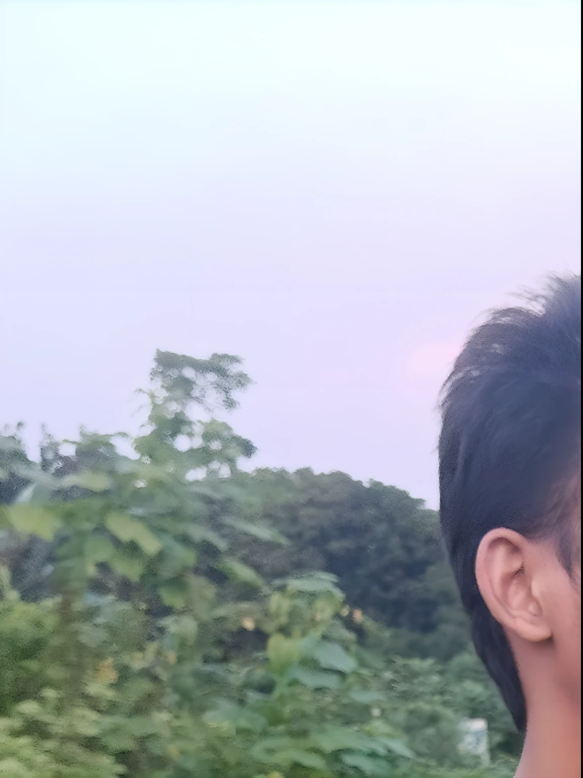 there is a man standing in a field with a frisbee, in front of a forest background, distant full body view, with lovely look, background is heavenly, very very low quality picture, profile pose, with accurate face, around 1 9 years old, scenary, taken with sony alpha 9, very artistic pose, during sunset