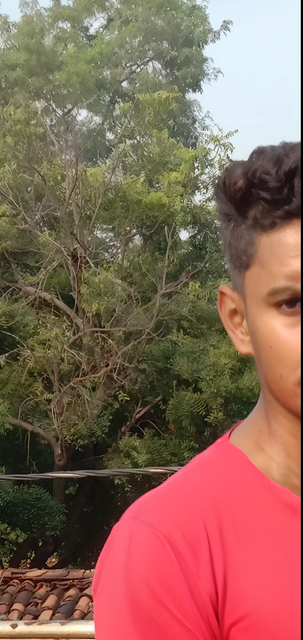 there is a man standing on a concrete surface with his hands in his pockets, red shirt, full body picture, in tshirt, red t-shirt, fit pic, with accurate face, wearing a muscle tee shirt, with a cool pose, red shirt brown pants, long hair and red shirt, around 1 9 , very very low quality picture, on rooftop