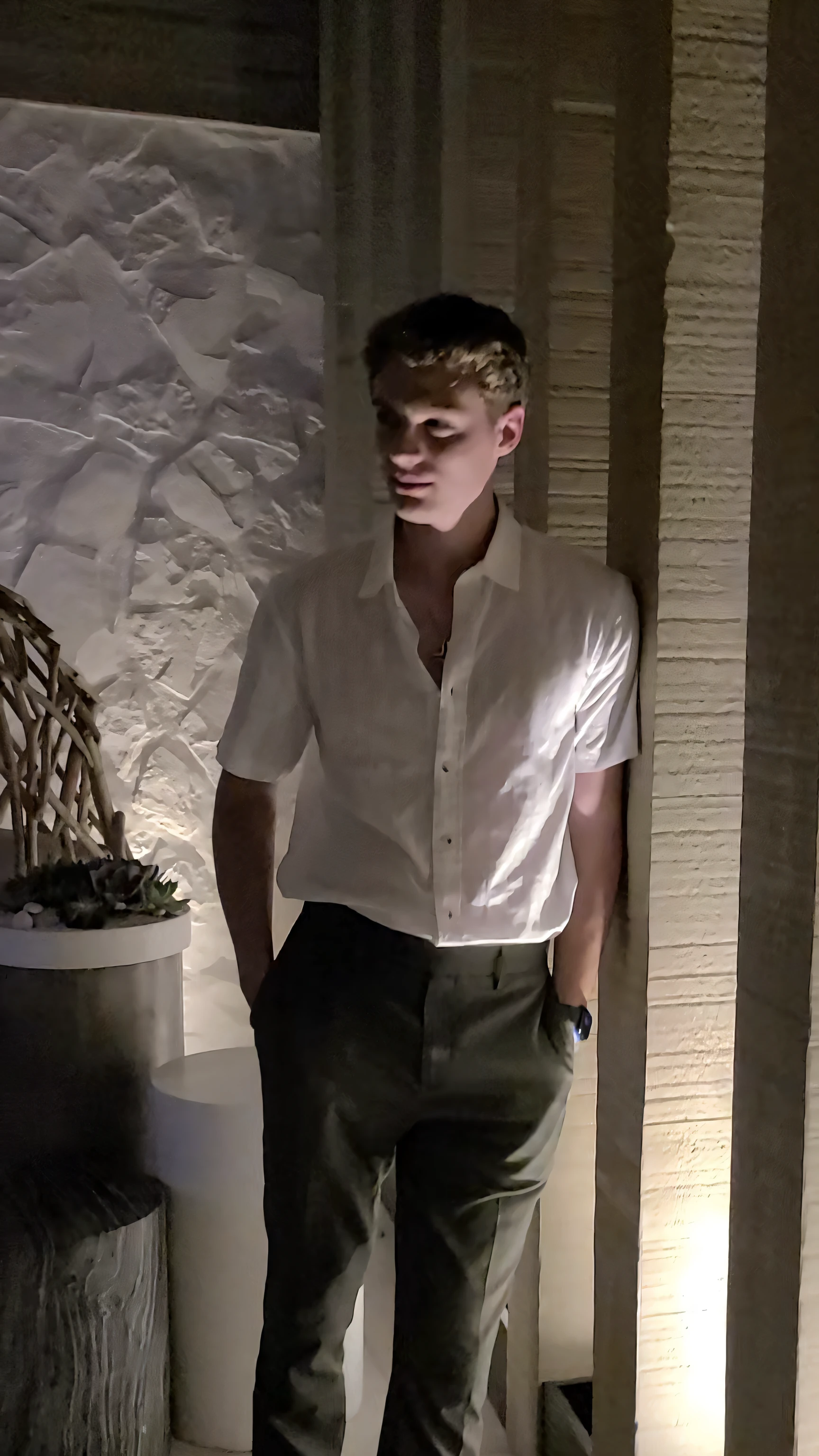 arafed man in white shirt and khaki pants standing in a room, standing in a dimly lit room, wearing a linen shirt, olive green slacks, wearing a white shirt, summer evening, wearing white shirt, full body picture, cinematic full body shot, wearing a white button up shirt, standing in a restaurant, in white clothes