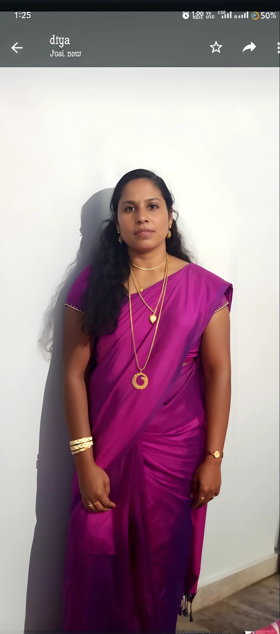 a woman in a purple sari standing against a wall, photo of a woman, 3 0 years old woman, 30 years old woman, about 3 5 years old, 3 0 years woman, professional picture, wearing a sari, portait image, 38 years old, (38 years old), 40 years old women, with kerala motifs