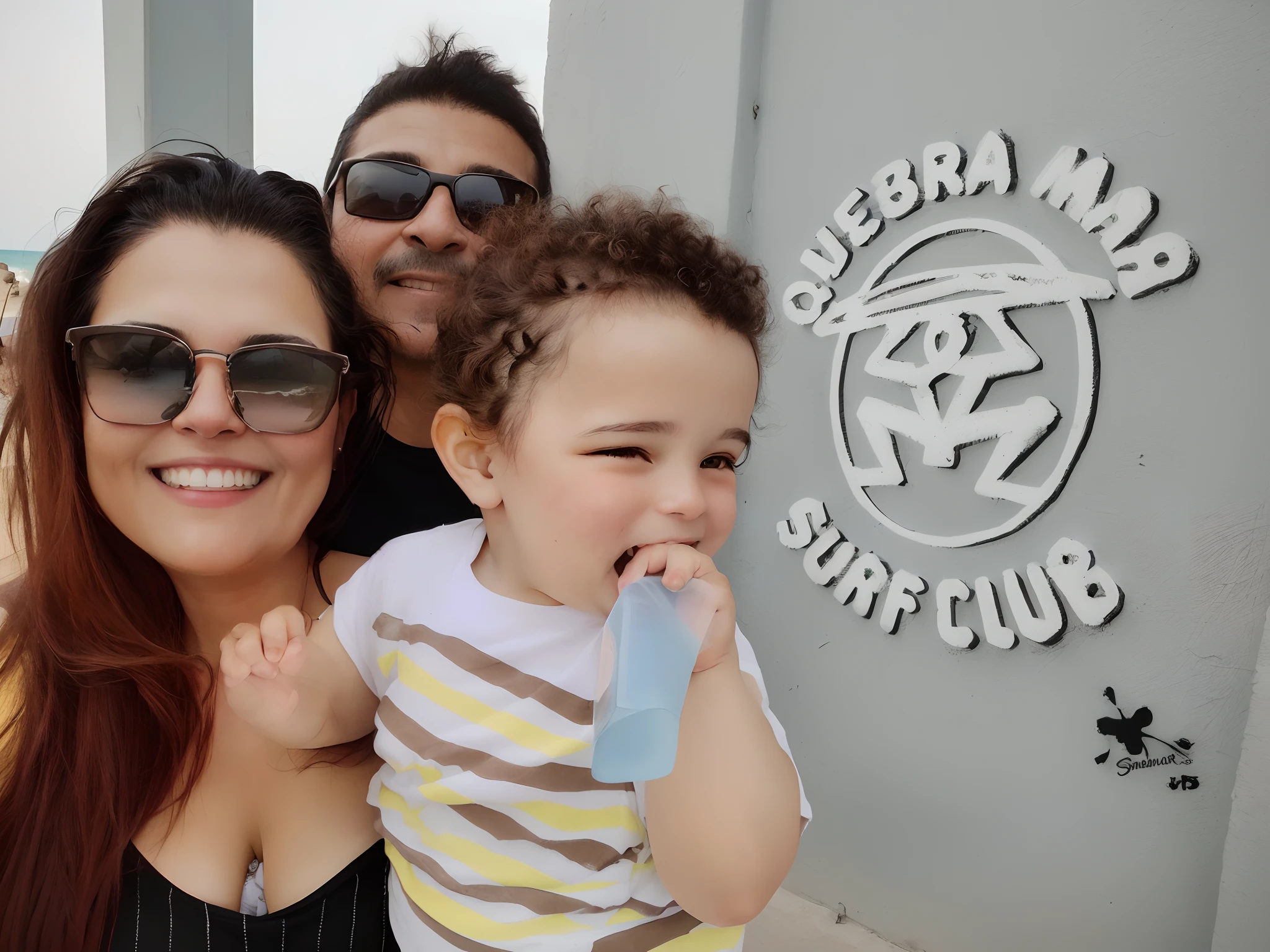 Smiling family posing for a photograph in front of a sign, marido esposa e filho, imagem de perfil, mateus 9 5, 3 5 year brazilian mother, Happy family, holiday photography, Selfie, Mulher de 30 anos de Cuba, Family photo, fotografia, na praia, no mar, Directed by: Samuel Silva, Directed by: Nandor Soldier
