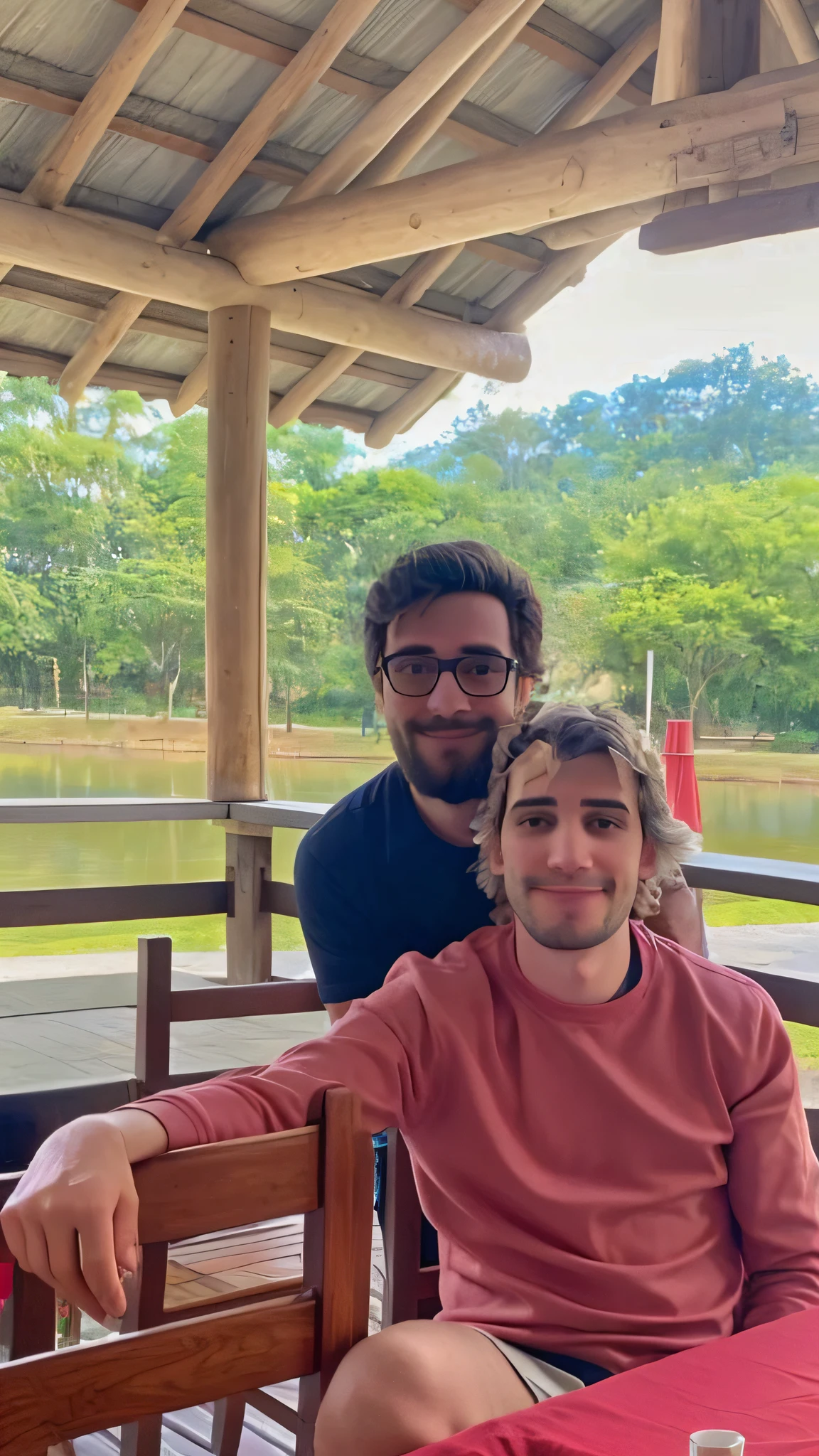 There are two men sitting at a table with a red tablecloth, In Sao Paulo, vale encantado,