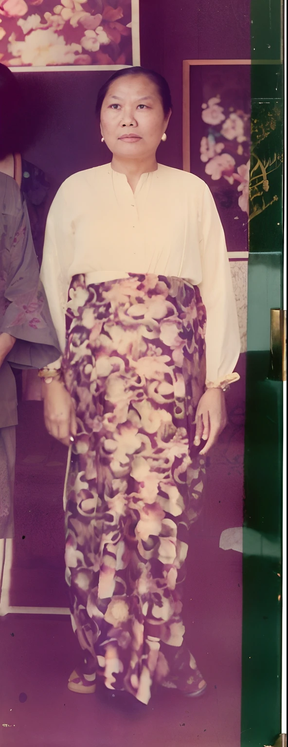 there are two people standing in front of a picture of a woman, wearing pink floral chiton, wearing floral chiton, catalog photo, grainy photo of an ugly woman, 1 9 7 0 s photo, 1970s photo, barong family member, grainy damaged photo, taken in the late 1970s, wearing ornate silk clothes