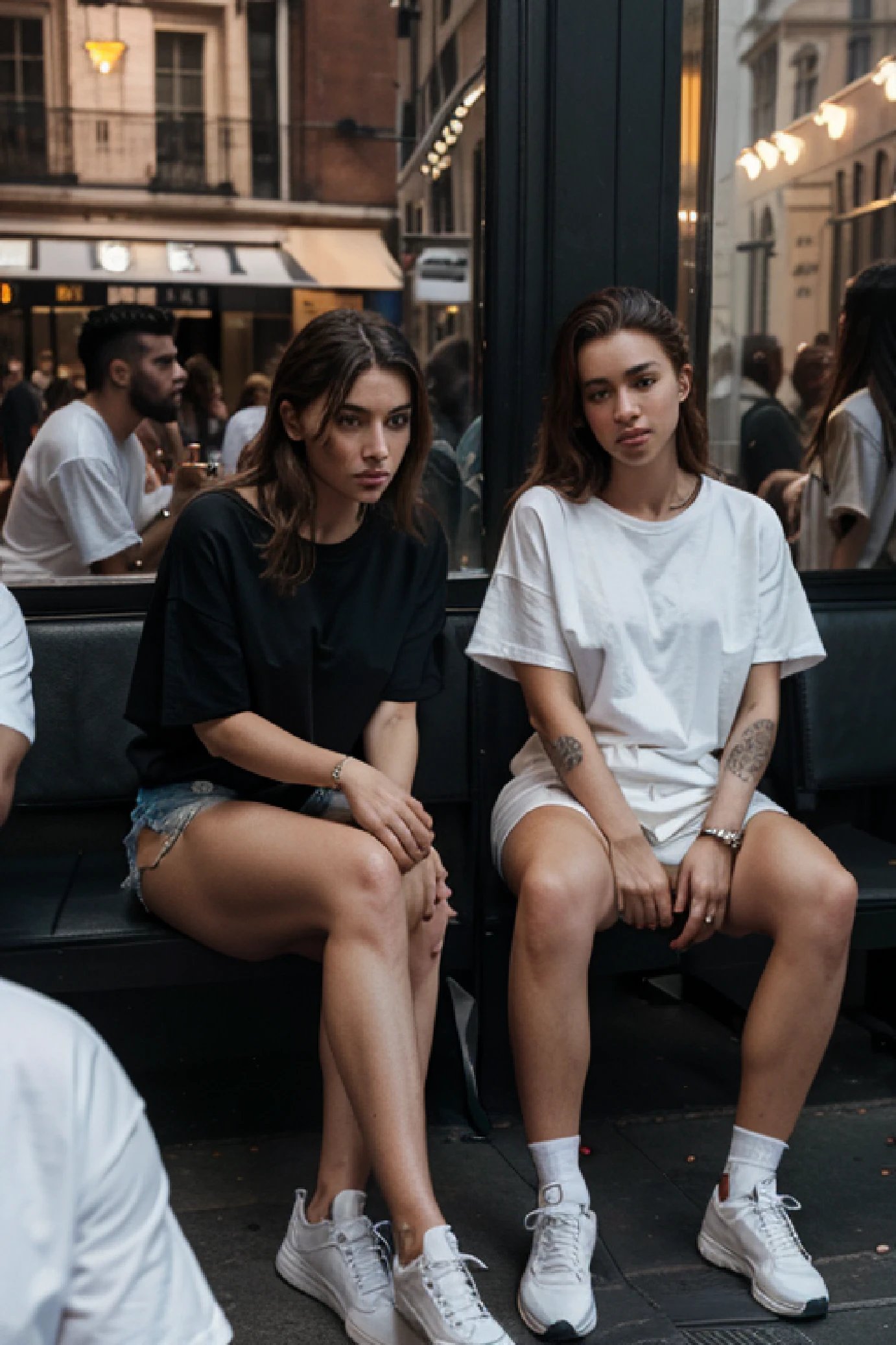 Hyper realistic, ultra detailed faces. group of models sitting outside fanelli cafe soho NYC, wearing fear of god style streetwear, loose, oversized t-shirt, fashion photoshoot,