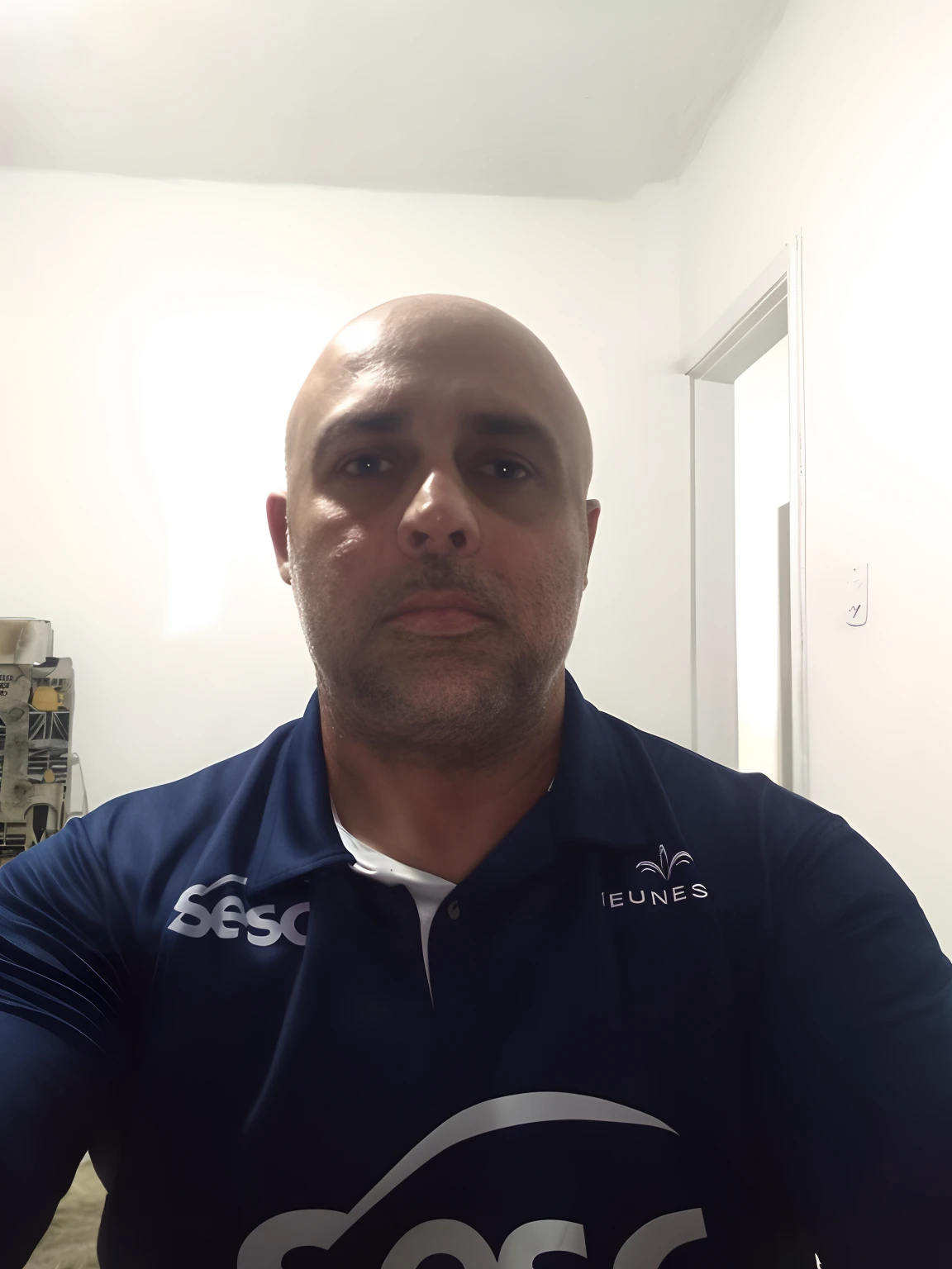 best quality,ultra-detailed,realistic:1.37,bald man,sports lover,football enthusiast,mild expression,centered,detailed eyes,detailed face,sporty outfit,athletic build,soccer ball,focus on the ball,green grass field,stadium atmosphere,cheering crowd,vibrant colors,soft lighting,portrait style.