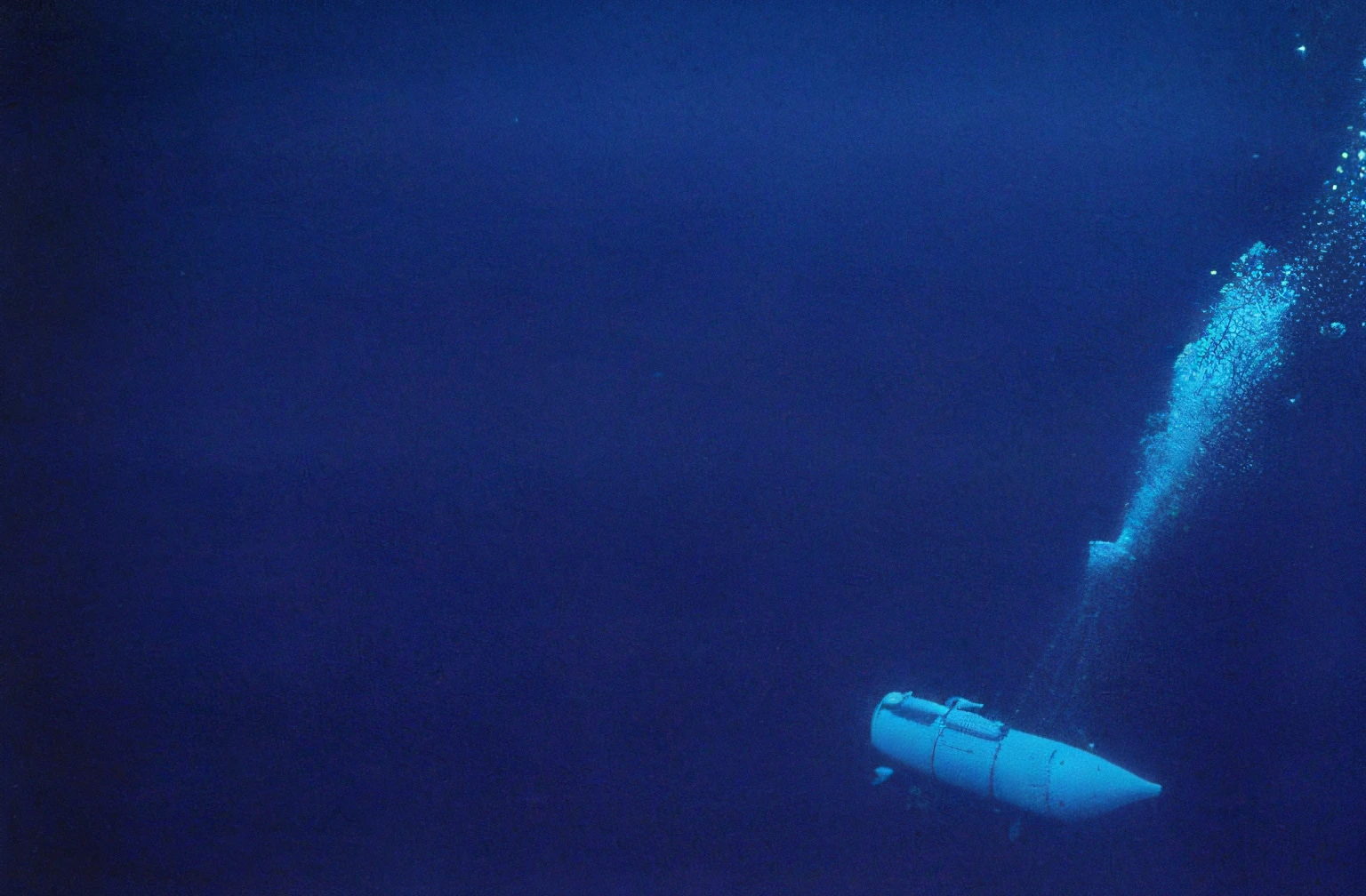 there is a boat in the water with a lot of bubbles coming out of it, submarine camera imagery, mariana trench, deep sea picture, submerged on titan, blue submarine no. 6, courtesy mbari, blue submarine no 6, courtesy of mbari, giant submarine, pre - ww 1 submarine, attacked submarine in background, photo of the middle of the ocean