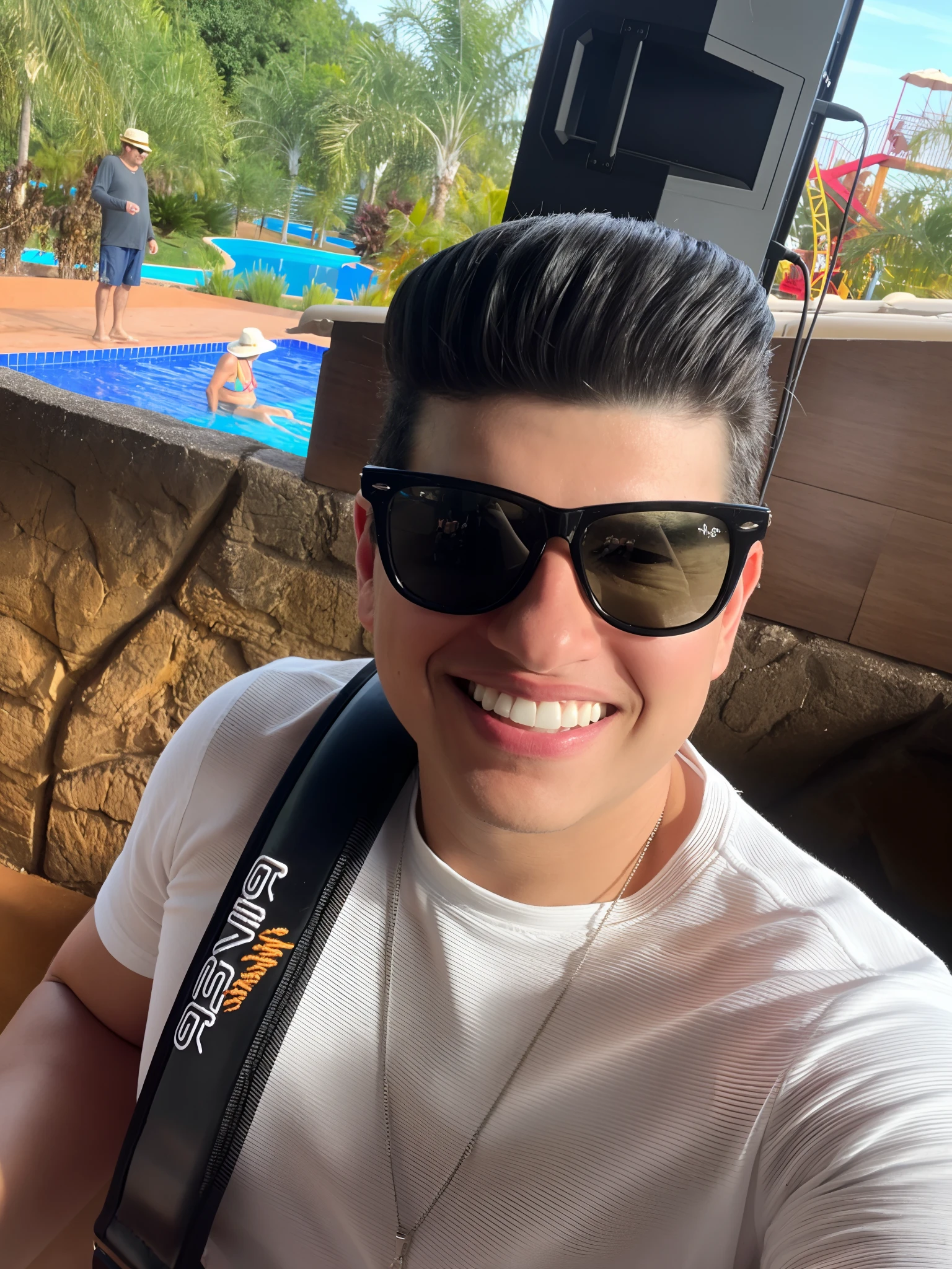Man holding a guitar in sunglasses smiling
