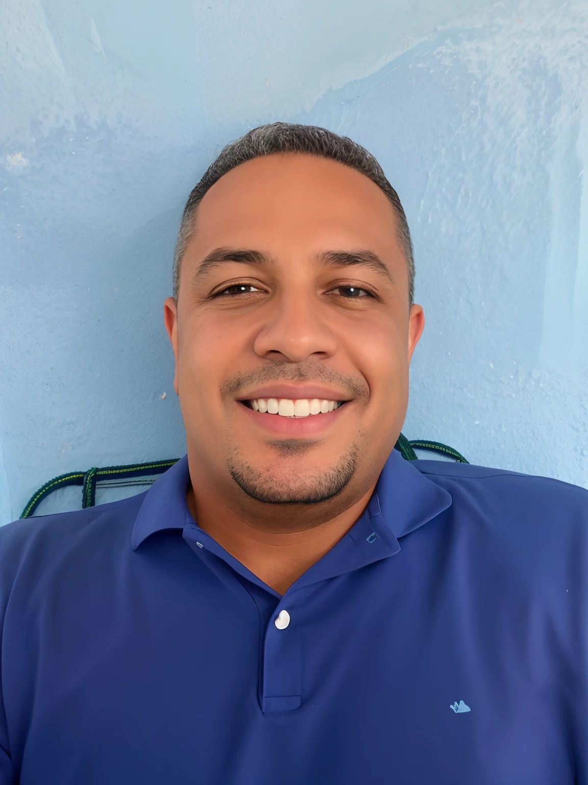 homem sorridente na camisa azul sentado na cadeira contra a parede azul, José Moncada, david rios ferreira, taken in the early 2020s, luis melo, icaro carvalho, imagem do avatar, andres rios, alphonse muca, Ronaldo Nazario, julio lacerda, Manuel Sanjulianblue, Dan dos Santos, Carmelo Blandino, imagem de perfil