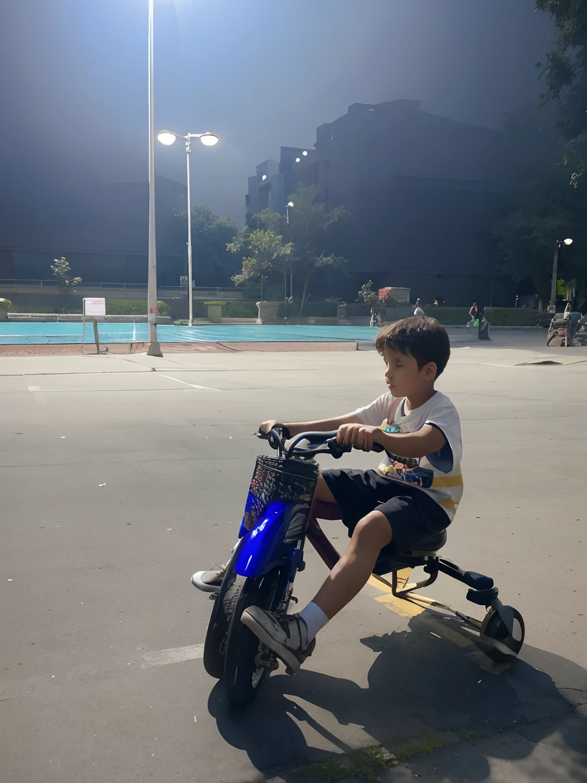 Boy sitting on a tricycle in the square