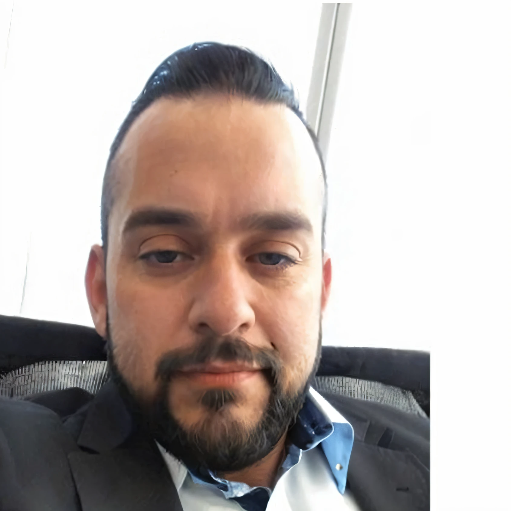 34 year oild man, short black beard, short black hair, blue shirt and black blazer