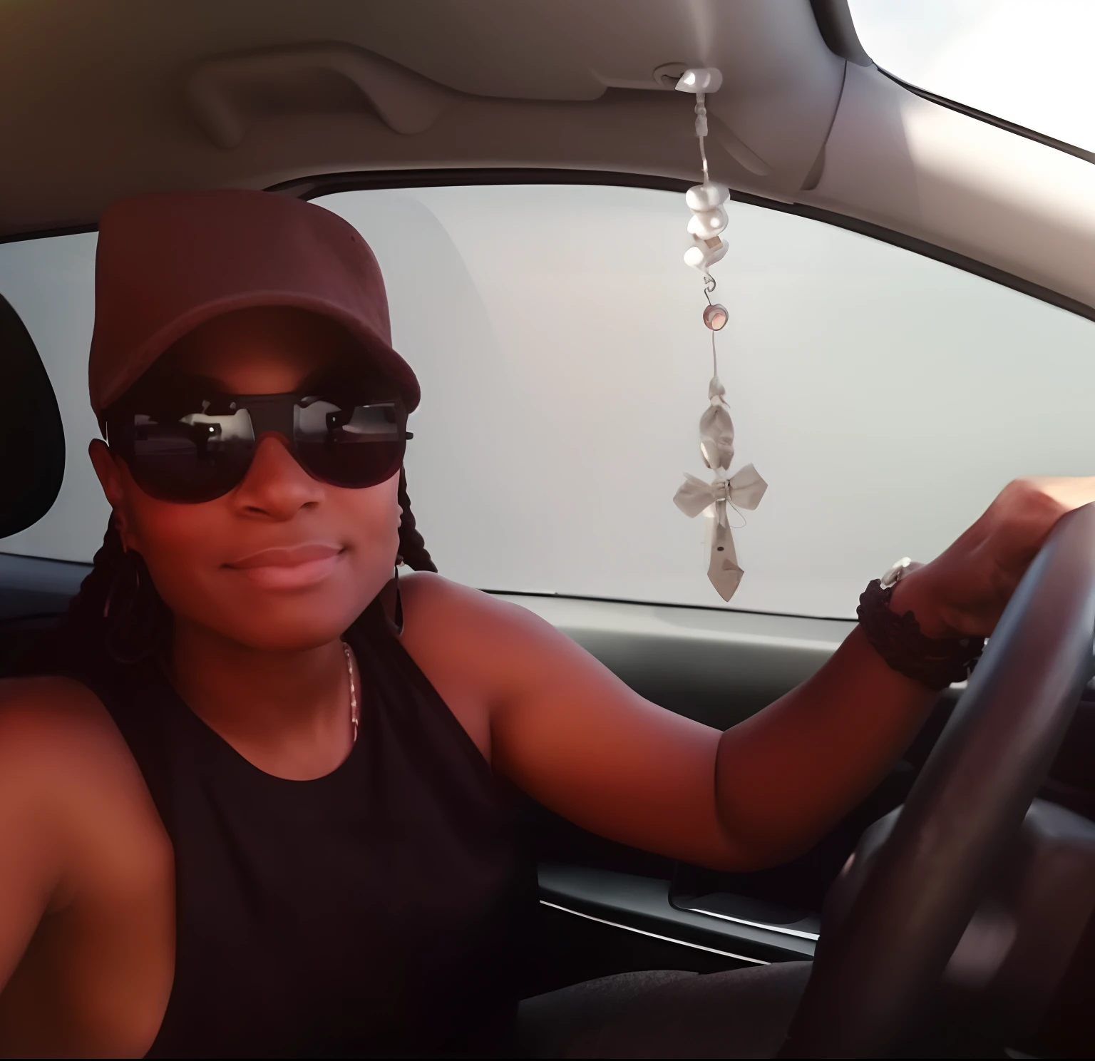 There is a mulatto woman, cabelo preto liso, Sitting in a car with hat and sunglasses, 30 anos