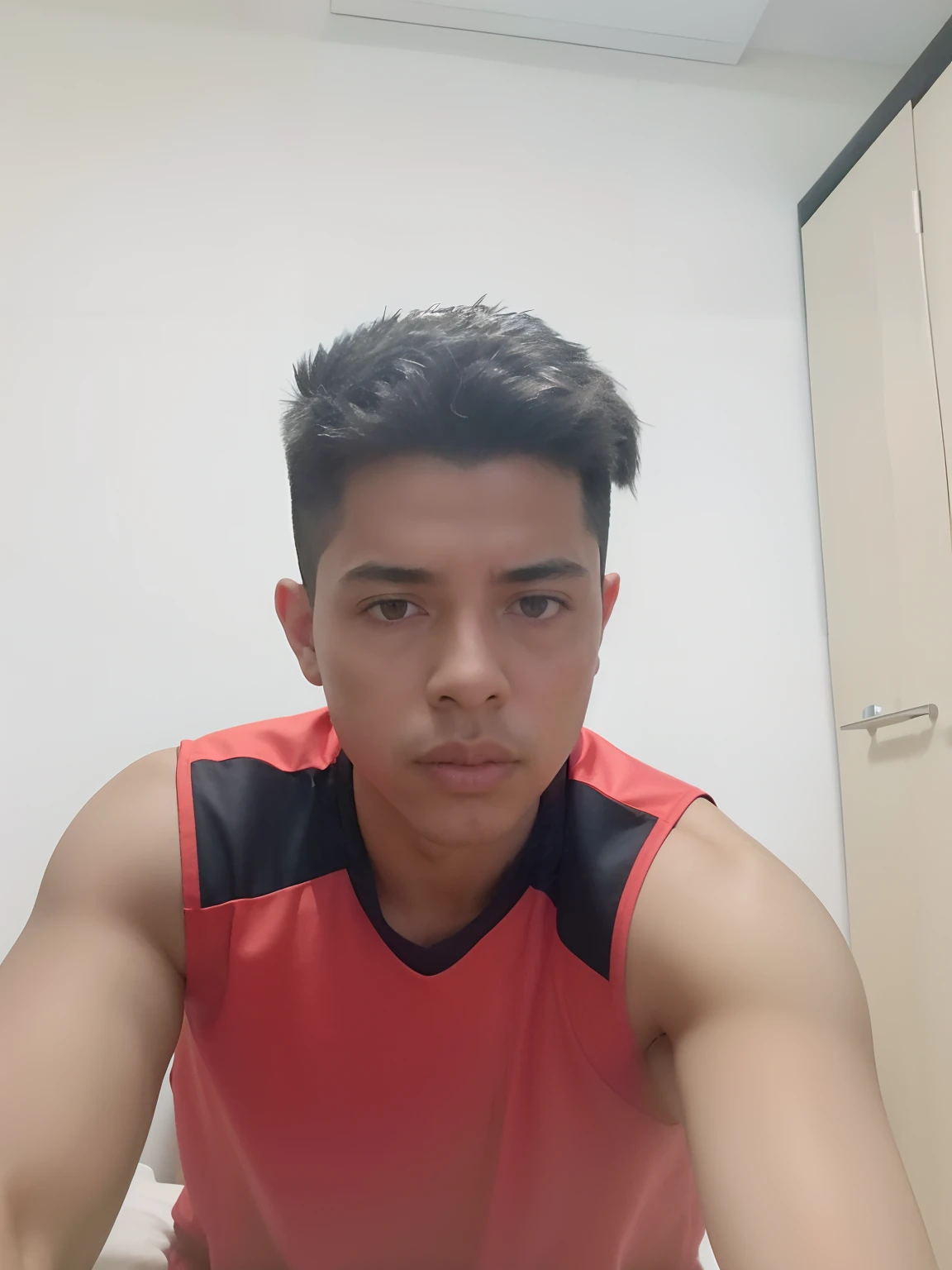 There is a young man sitting on a bed with remote control, caio santos, 18 anos, mateus 9 5, icaro carvalho, Ronaldo Nazario Fenomeno, 21 anos, 2 2 anos, 1 6 anos, 2 3 anos, Carmelo Blandino, Ronaldo Nazario