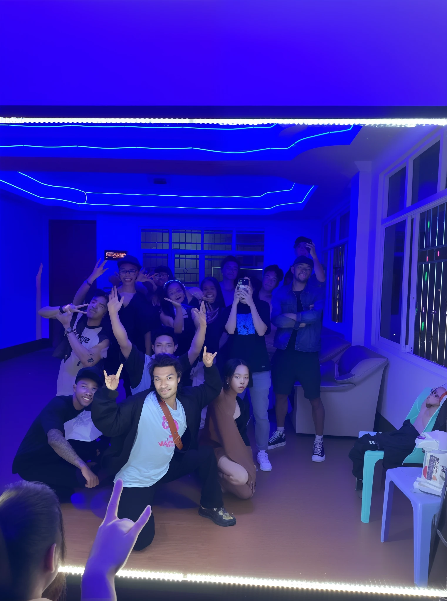 there are many people posing for a picture in a room, group photo, at future neon light rooftop, group of people in a dark room, with neon lighting, with neon lights, taken in 2 0 2 0, photo taken in 2 0 2 0, “house music rave with dancers, (((low light))), hard lighting!, rave party