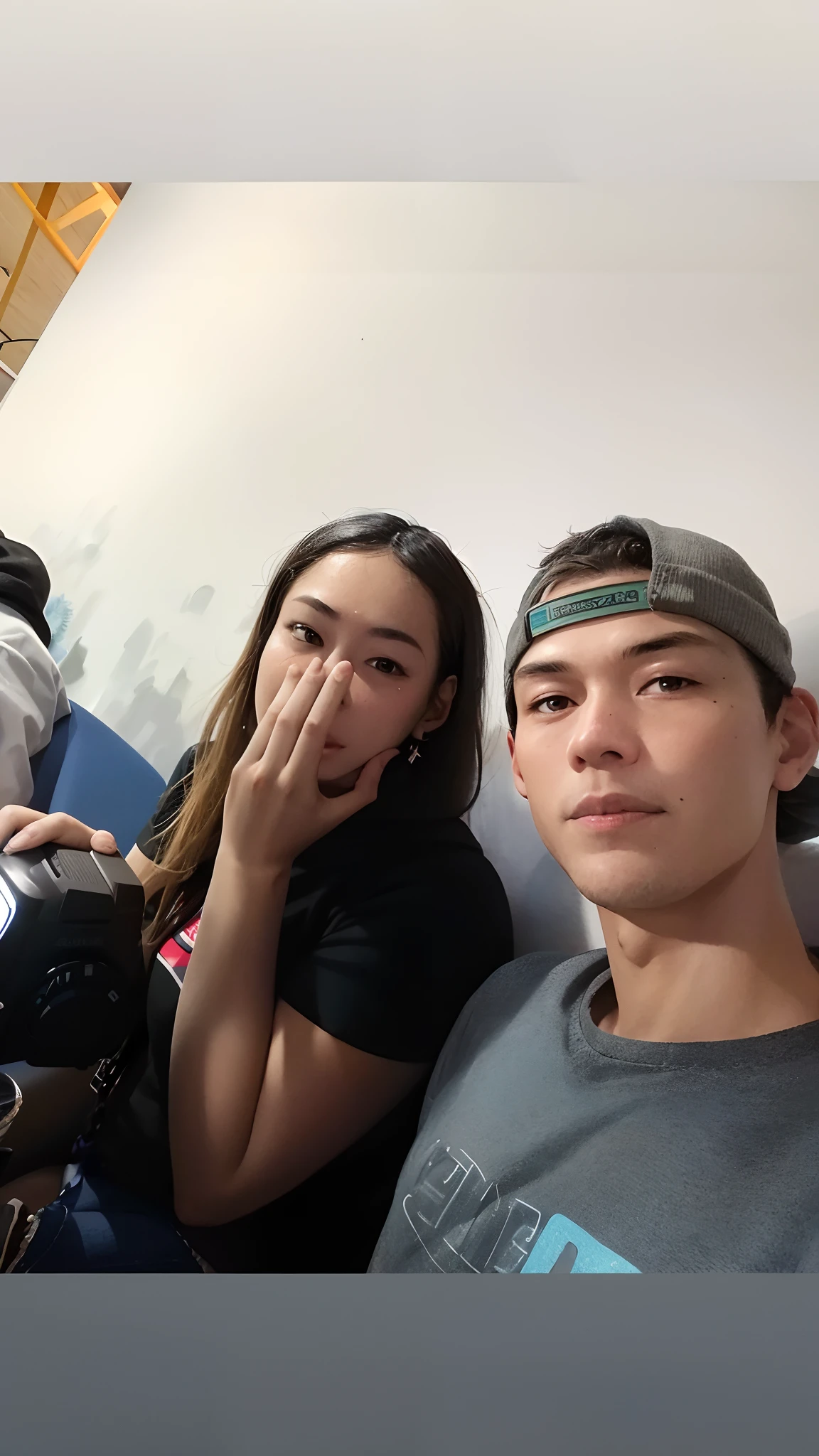 There are two people sitting next to each other in a room, looking distracted and awkward, Jordan Grimmer e Natasha Tan, Tyler Edlin e Natasha Tan, imagem de qualidade muito baixa, not smiling, they are very serious, foto muito precisa, Assumido em Go Pro Hero8, Roomies, entediado, vacation photo, selfie shot straight on angle