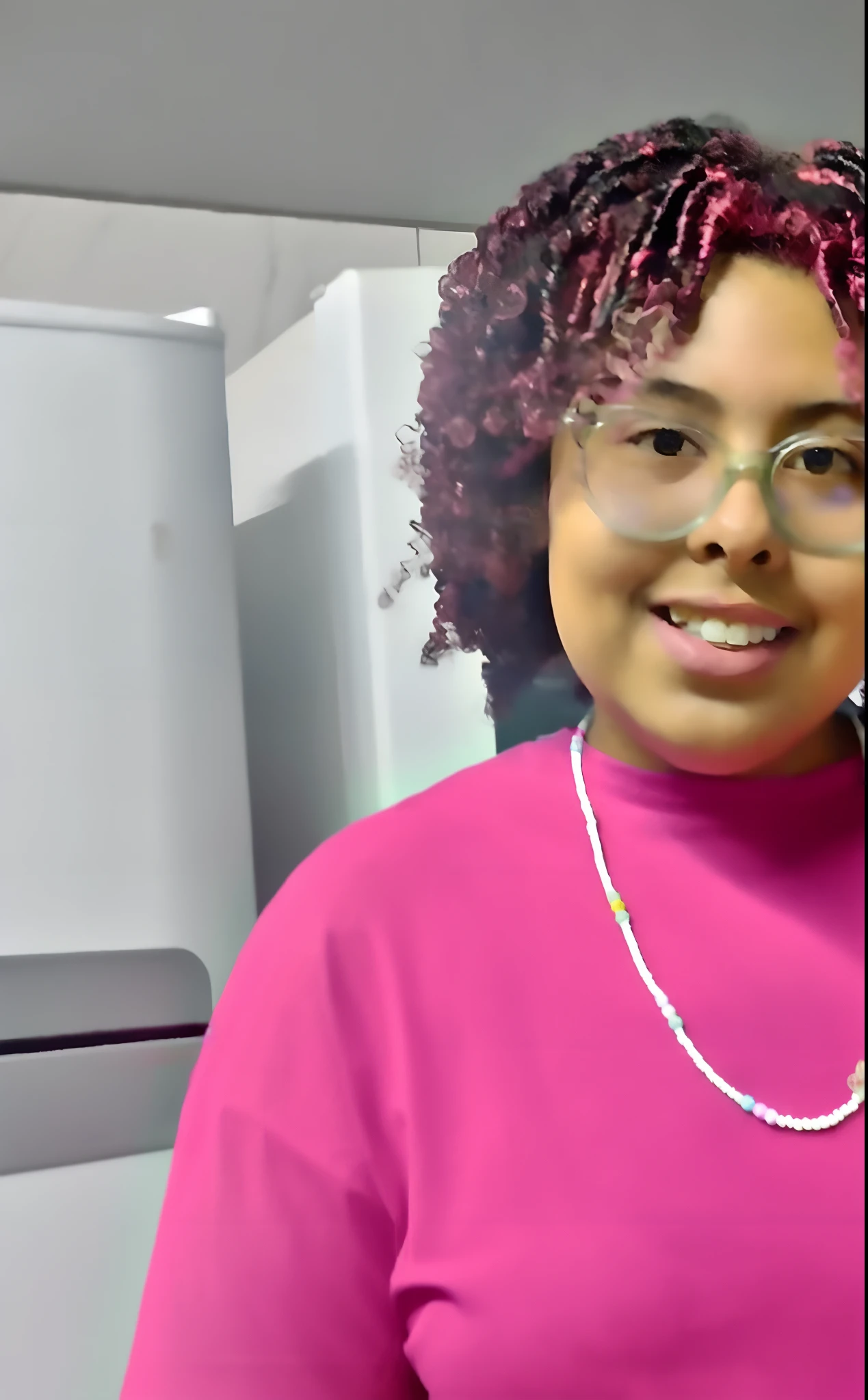 There's a woman standing in a kitchen holding a glass, wearing a pink head band, inspirado por Lily Delissa Joseph, taken in the early 2020s, vestindo chiton floral rosa, photo shoot, com afro, Parece Fabiula Nascimento, na cozinha, Mulher de 30 anos de Cuba