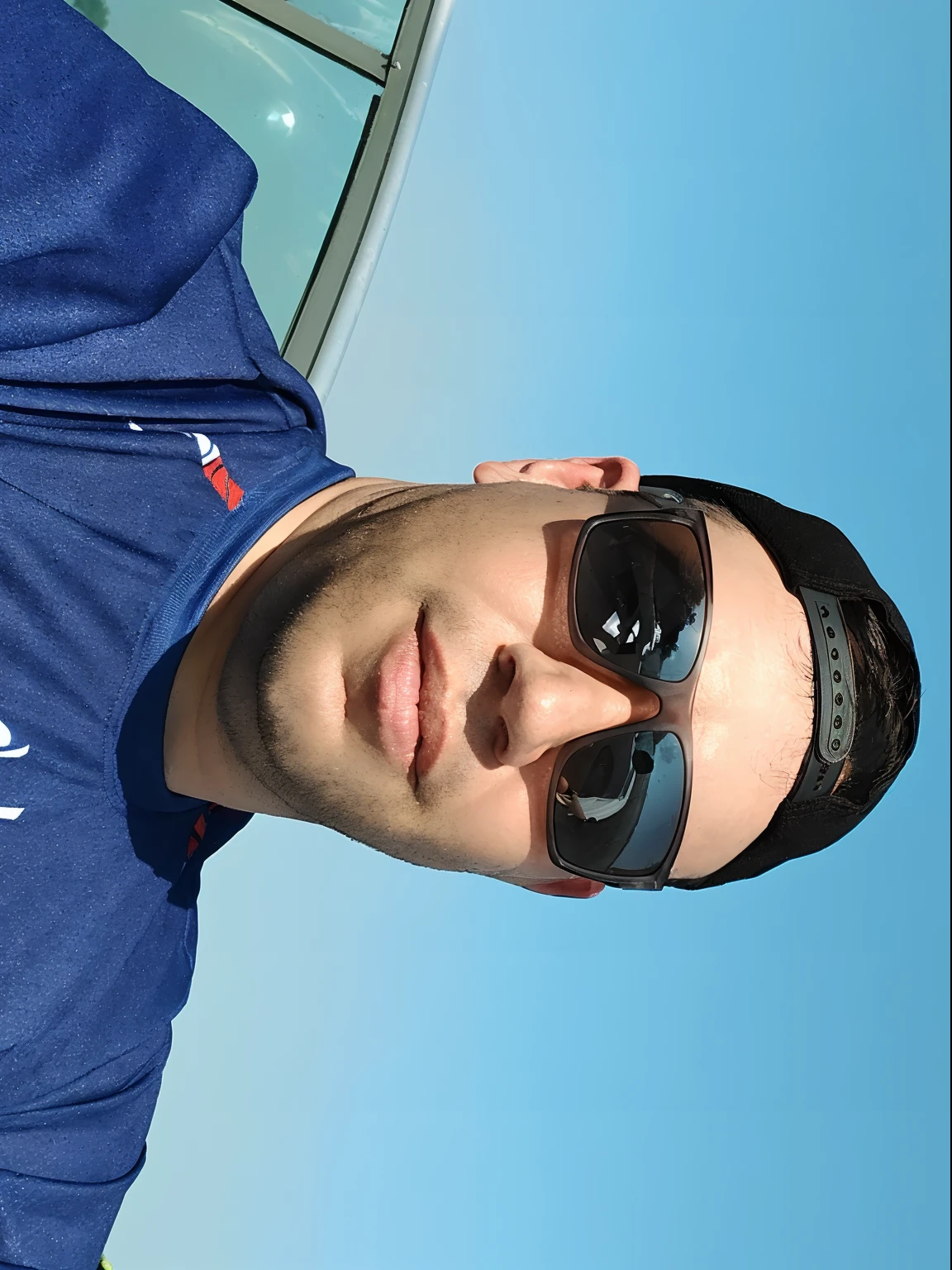 there is a man wearing sunglasses and a blue shirt, Fotografia selfie 8k, selfie shot straight on angle, Alto FOV, selfie de um homem, vacation photo, Looking Up The Sky, clear blue skies, looking-into-camera, looking-into-camera, em tempo ensolarado, face looking skyward, Retrato Grande Angular, foto selfie, front facing the camera