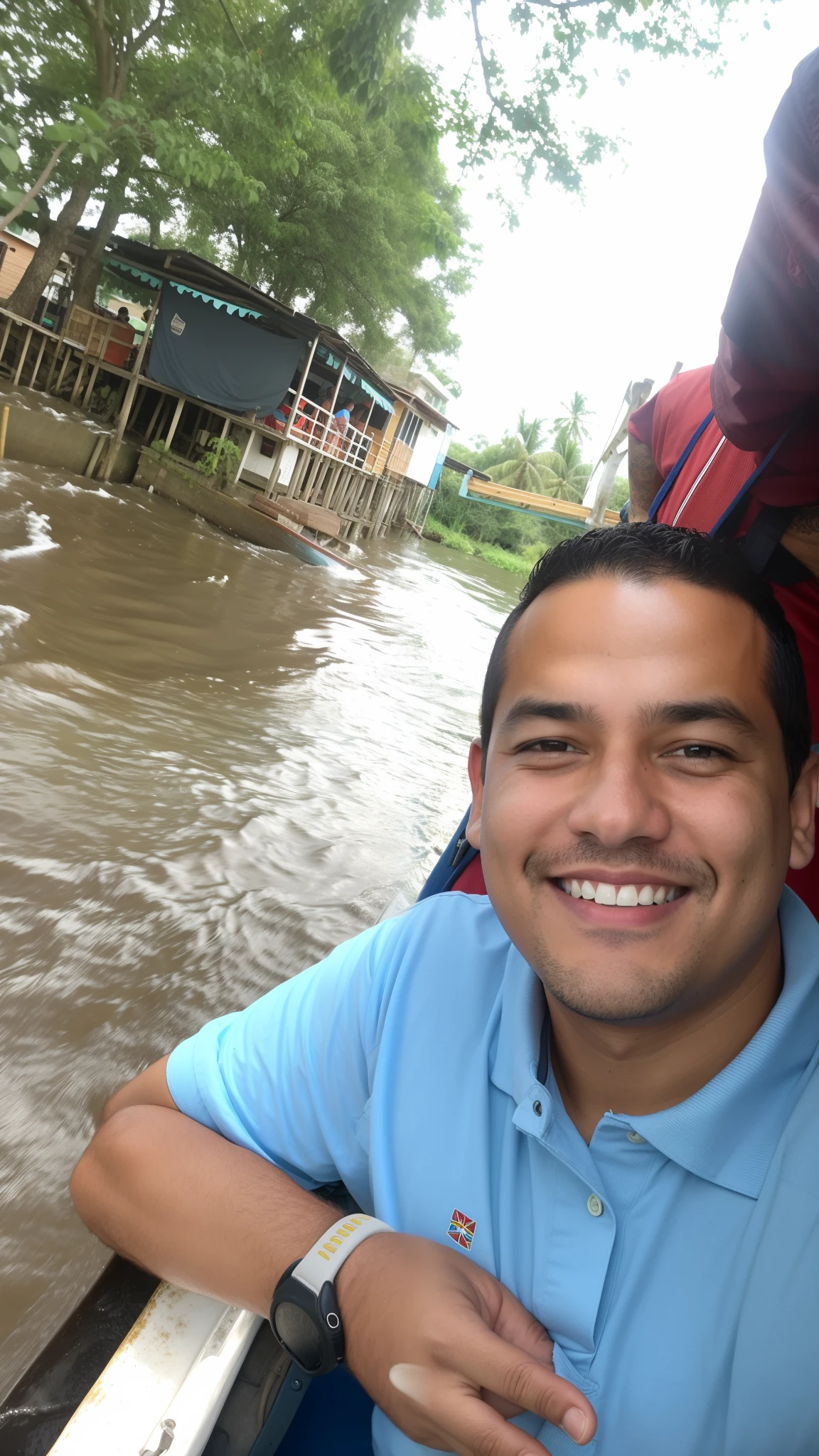 Smiling man in blue shirt on boat on river with houses in the background, river in the background, andres rios, Joel Torres, en un barco, Christian Orrillo, river in front of him, andrew gonzalez, por Byron Galvez, in a river in the jungle, muy levemente sonriendo, david villegas, Brian Pulido, Danilo Torres, Alex Flores