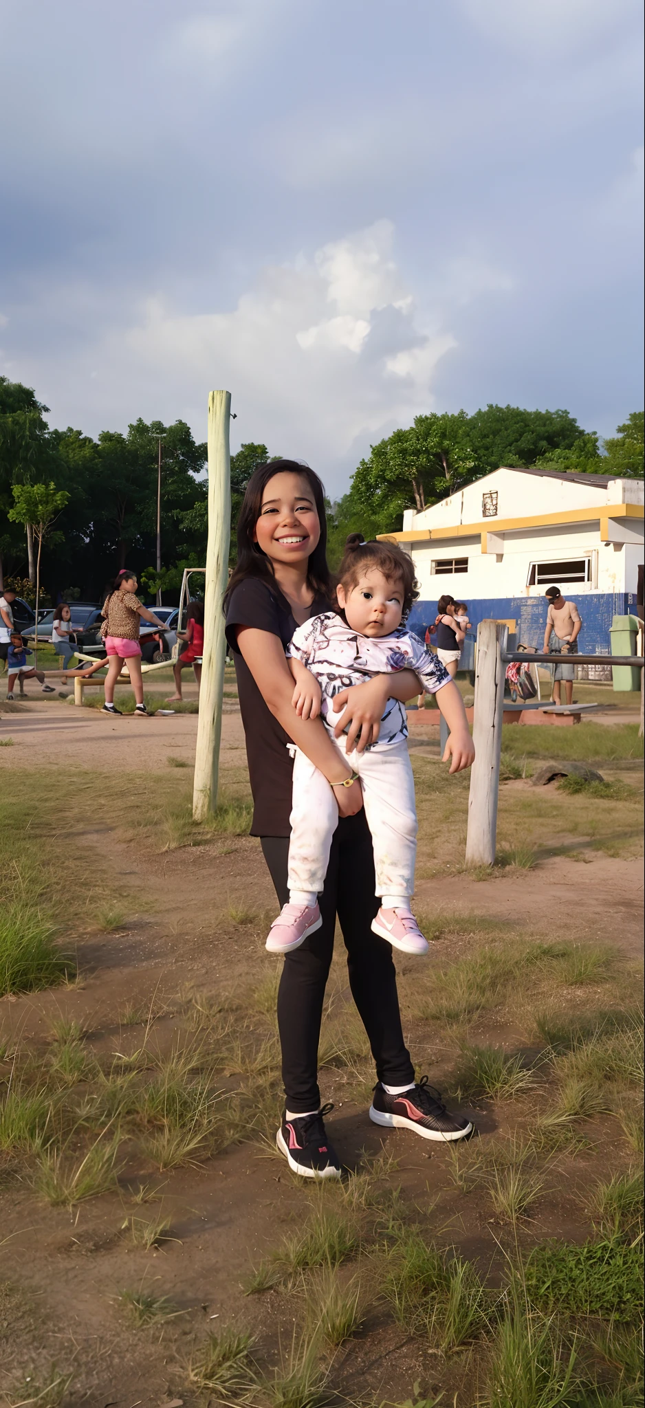 There's a girl holding a baby ifield, with a kid, com uarque ao fundo, com um parque nos fundos, no parque,