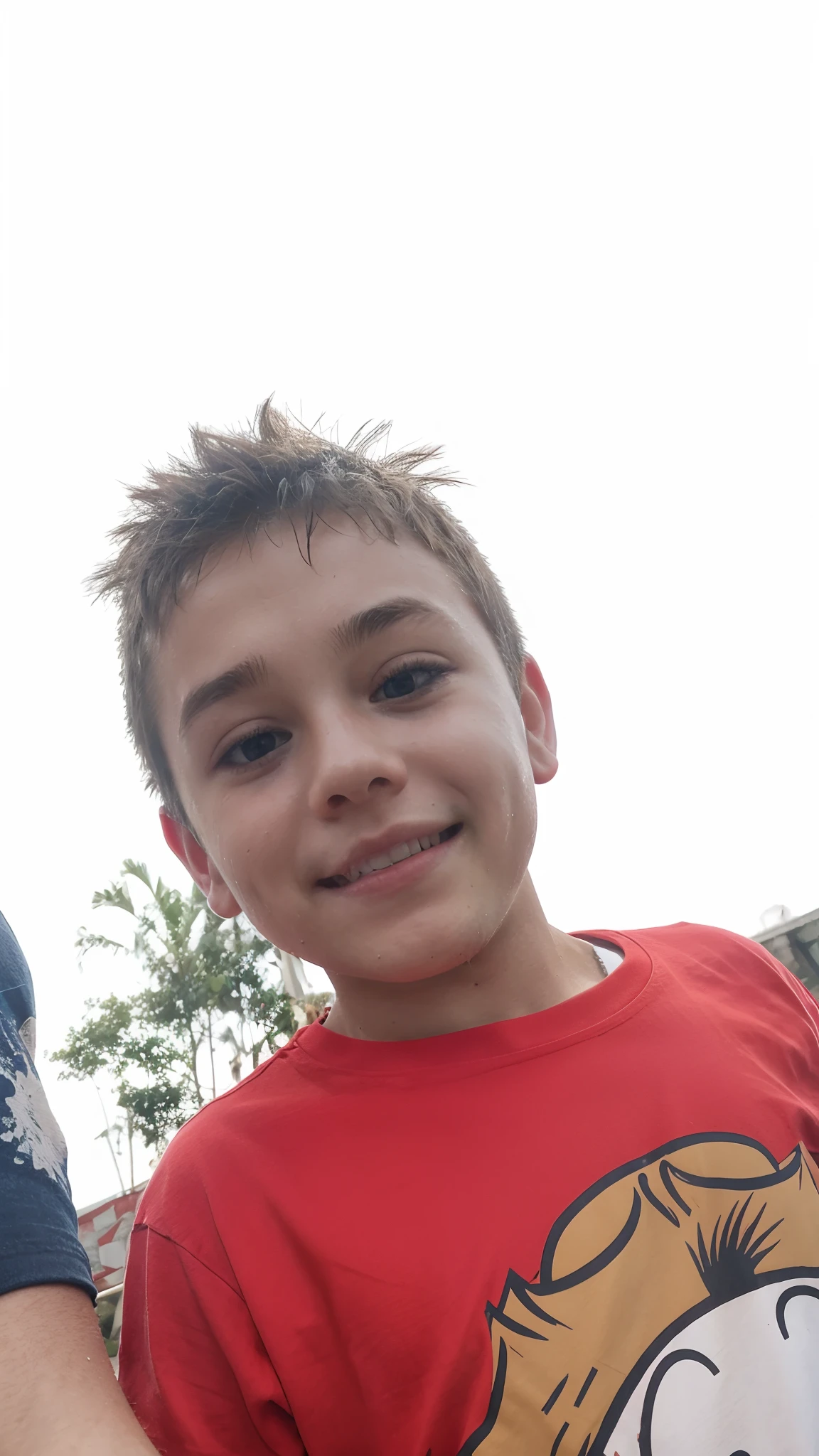 Boy with a red t-shirt, smiling, sweaty and messy hair