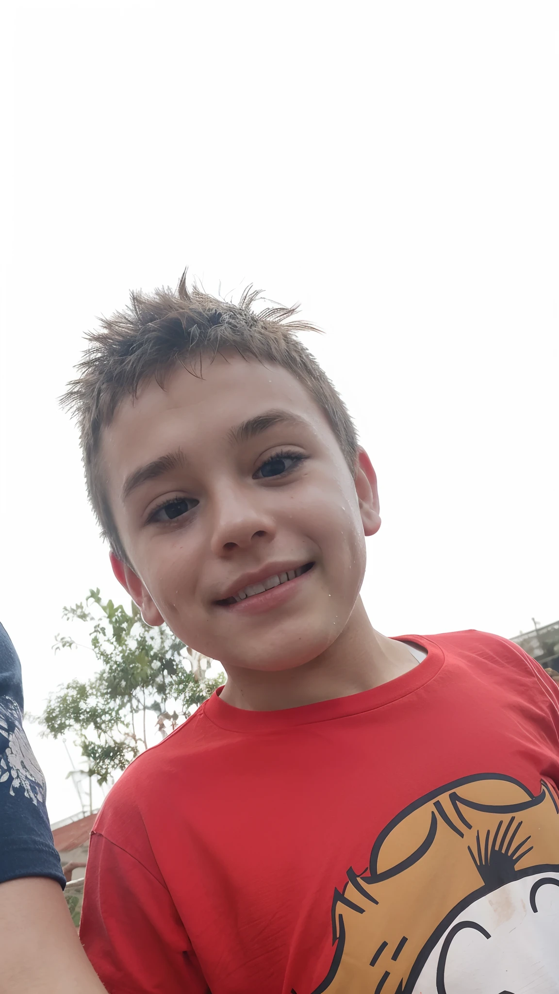 Boy with a red t-shirt, smiling, sweaty and messy hair