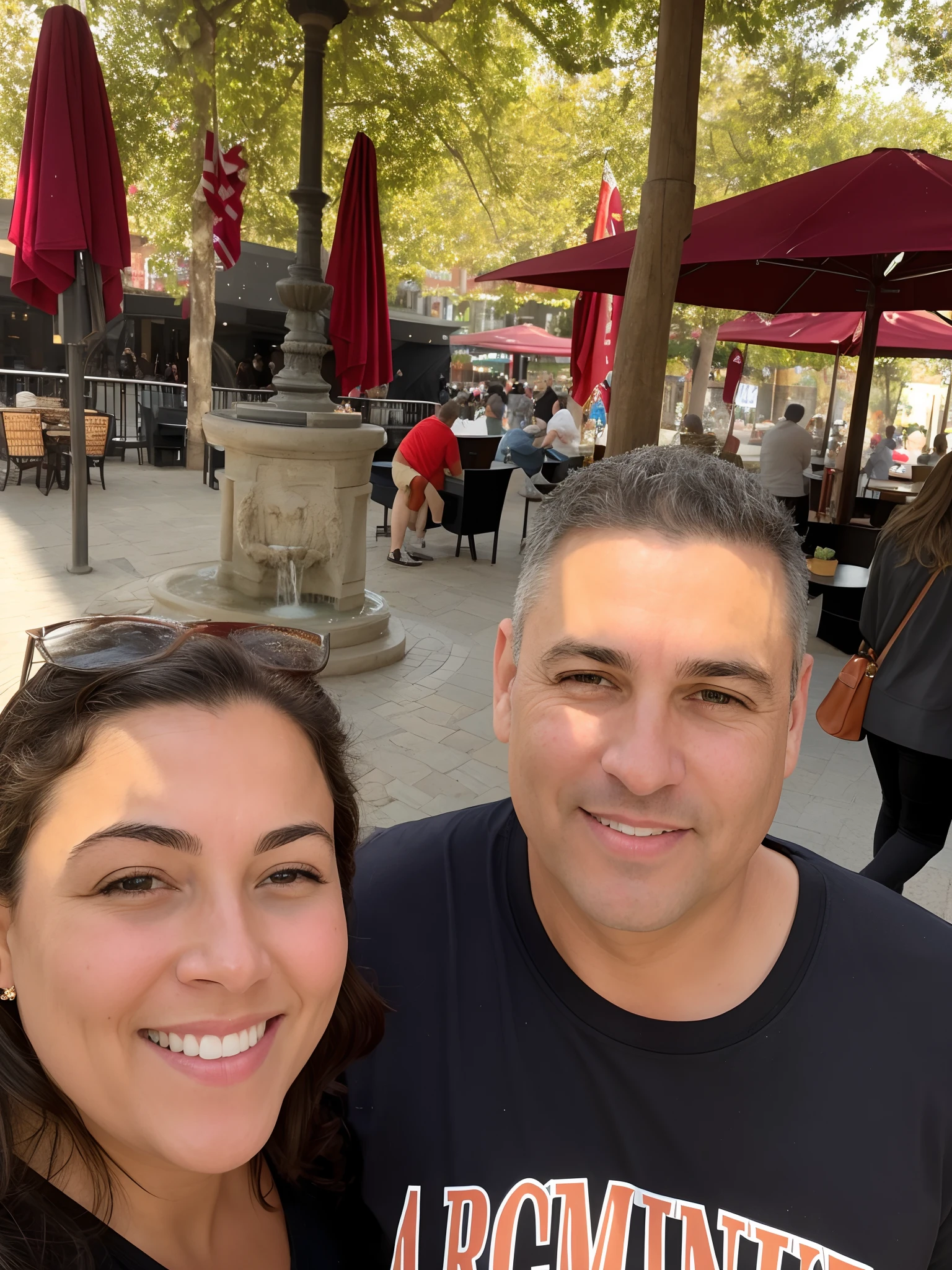 smiling man and woman standing in front of a fountain in a city, in a city square, in a sidewalk cafe, taken in the early 2020s, momma and papa, photo on iphone