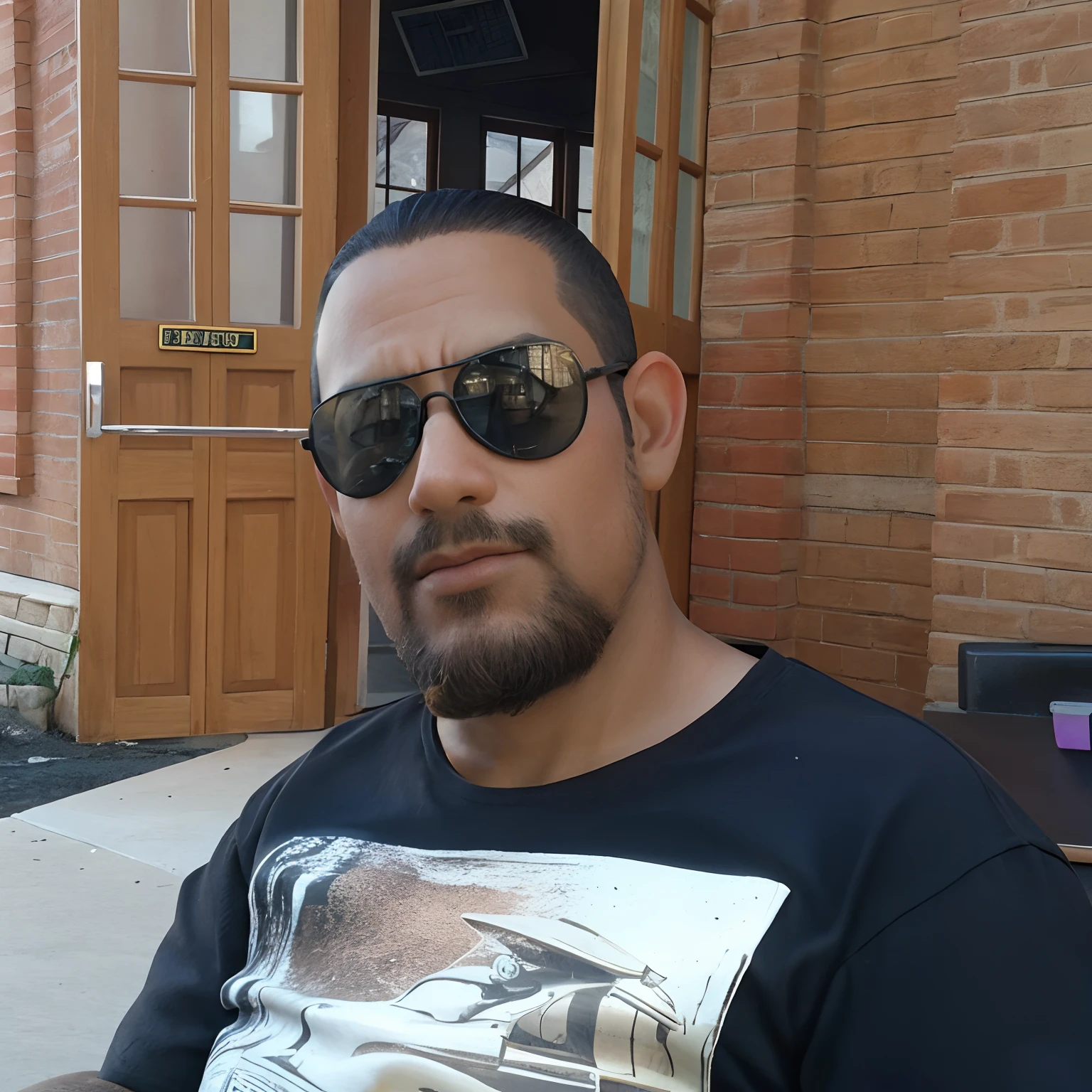 Man sitting in black t-shirt and sunglasses