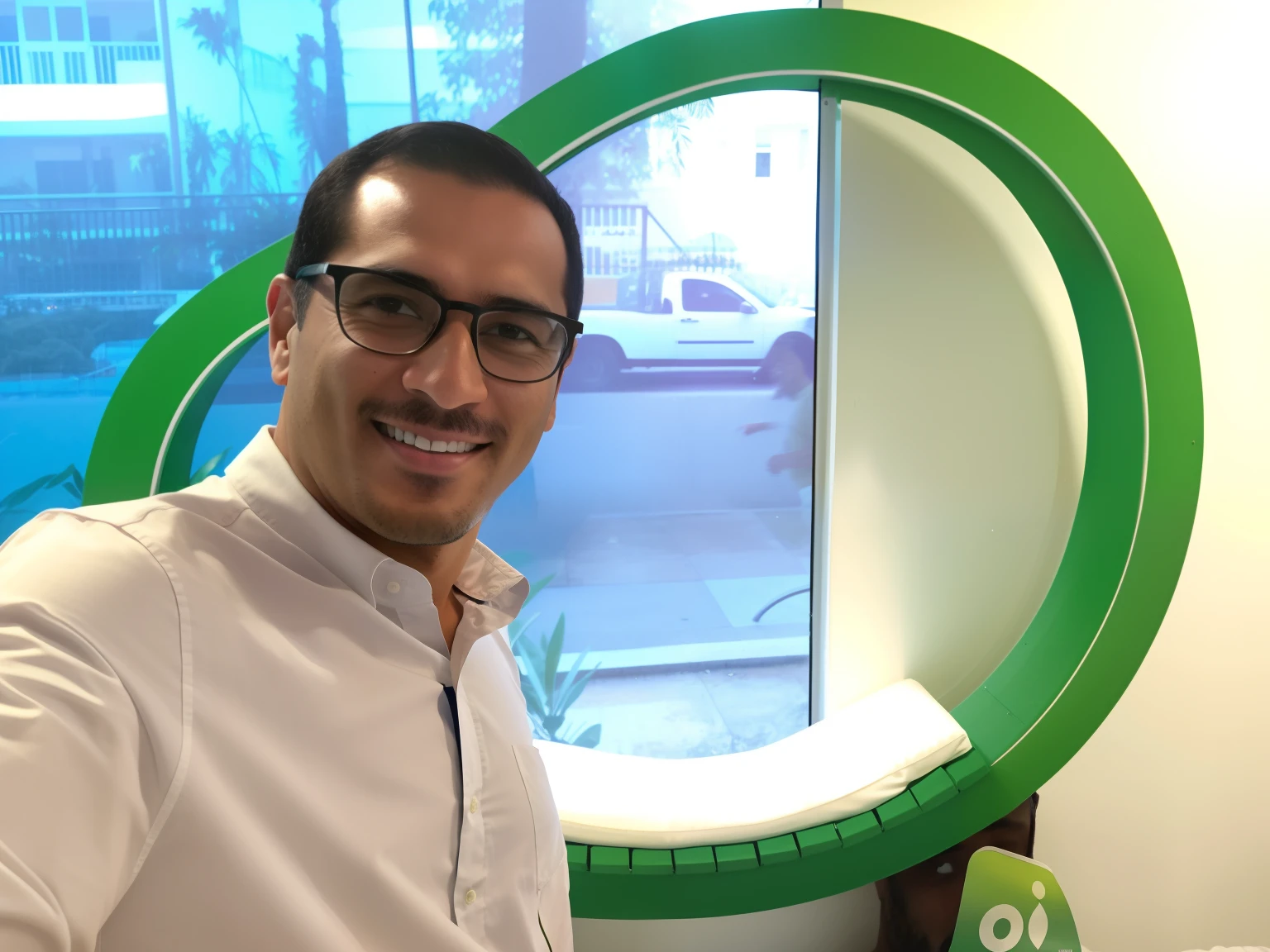 Smiling man in white shirt and glasses in front of a green circular window, david rios ferreira, Arauto Ortega, Jorge Lacera, icaro carvalho, ignacio fernandez rios, Cristiano Orrillo, daniel mirante, Pablo Oliveira, Carmelo Blandino, danilo torres, andres rios, In Sao Paulo, Directed by: Alejandro Obregon