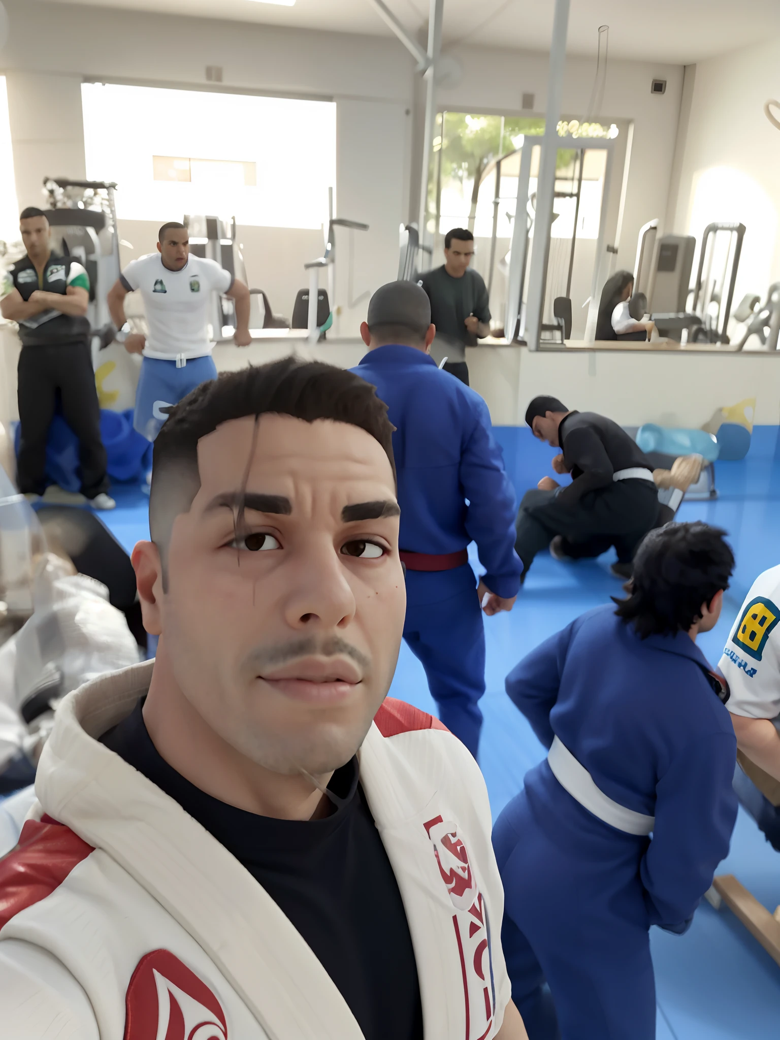 there are many people in a gym with one man in a white belt, david rios ferreira, ronaldo nazario, icaro carvalho, caio santos, ronaldo nazario fenomeno, edu souza, sao paulo, Henry Alvim Correa, joe alves, fernando guerra, edon guraziu, resting after a hard fight