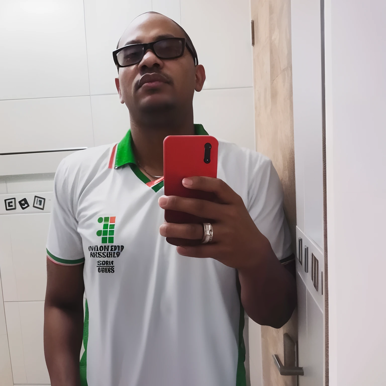 there is a man taking a selfie in a bathroom mirror