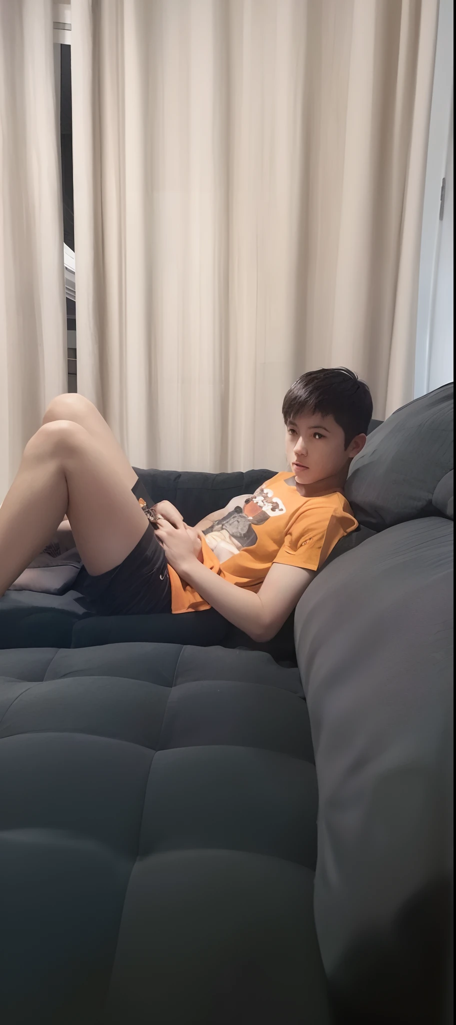 There's a boy lying on a couch with his feet up, sitting on couch, relaxing on the couch, sitting on the couch, sitting on a couch, relaxing on a couch, relaxing after a hard day, seated in a couch, sitting on couch, at the sitting couch, resting after a hard fight, on a couch, Brincando