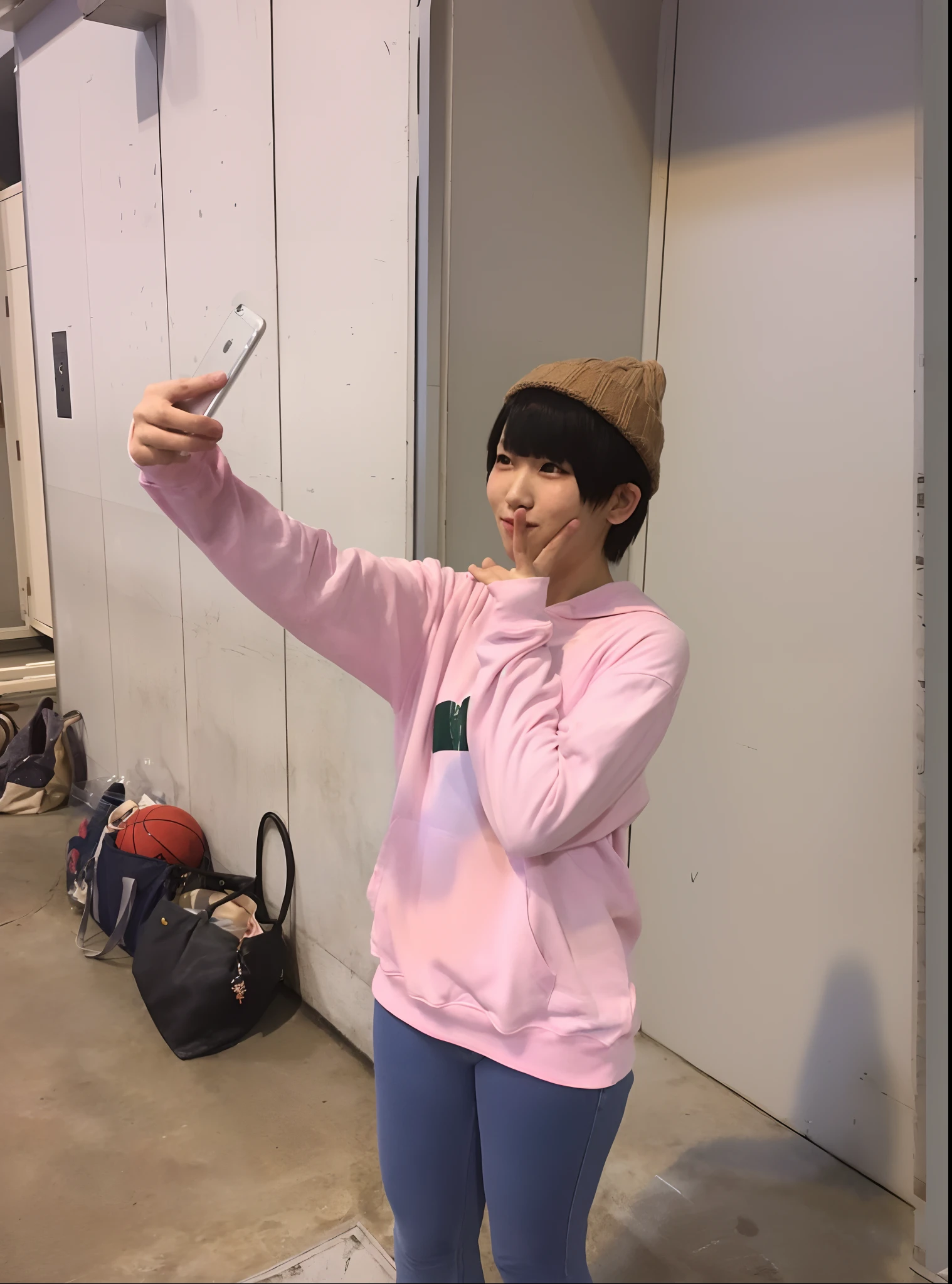 A girl taking a selfie with her mobile phone, wearing a pastel pink hoodie, different poses, wearing streetwear, with her index finger raised. She is Kim Doyeon, and she is known as "@akasatanaha" on Twitter. The girl's appearance is detailed, with beautiful eyes, nose, and lips. The image is of the highest quality, with 4k or 8k resolution, ultra-detailed, realistic, and photorealistic. The art style is portrait, with vivid colors and professional lighting. The overall color tone of the image is pastel, with soft and gentle lighting.