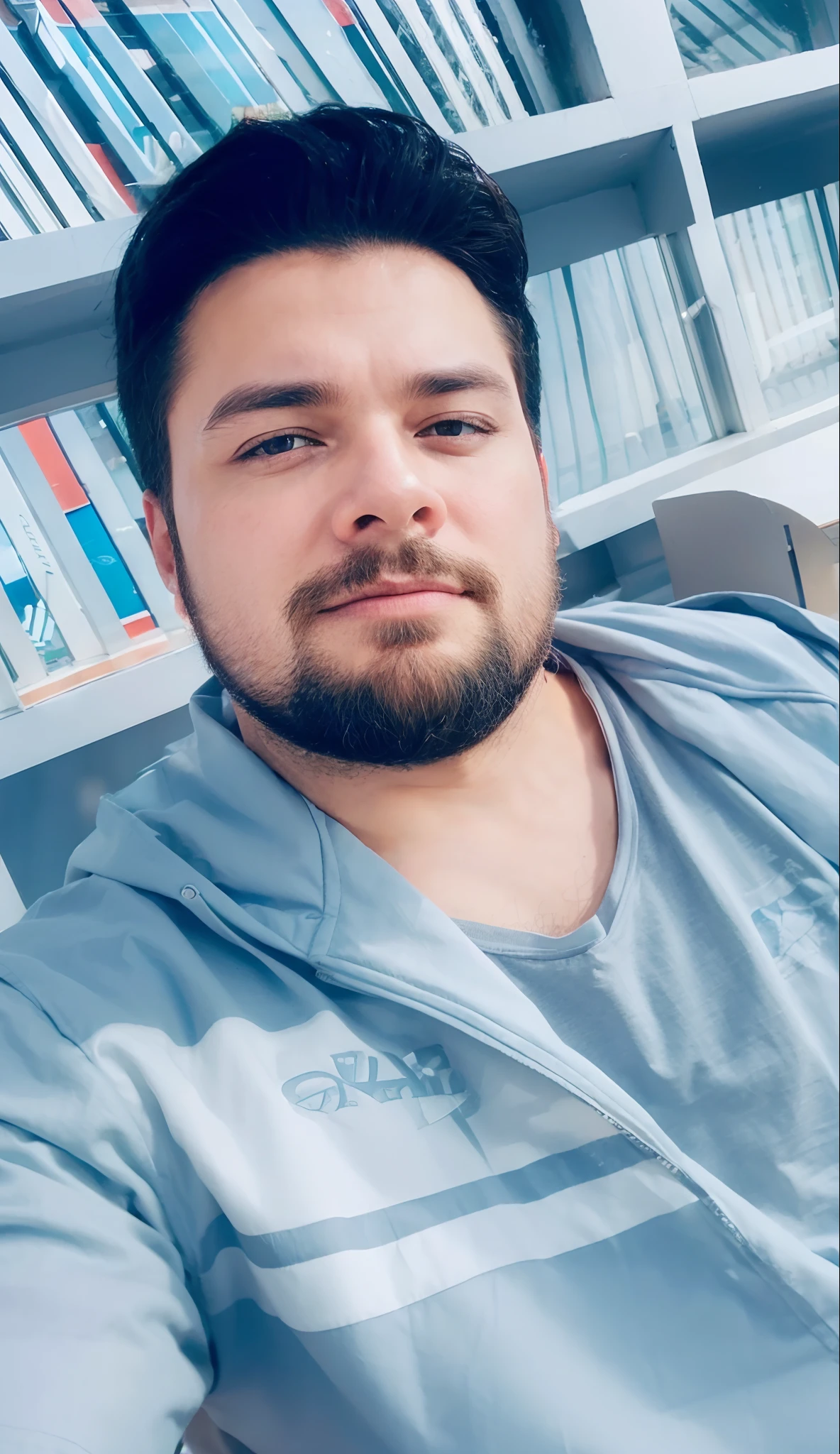 With executive clothes, big beard and in the background the view from the window of a building
