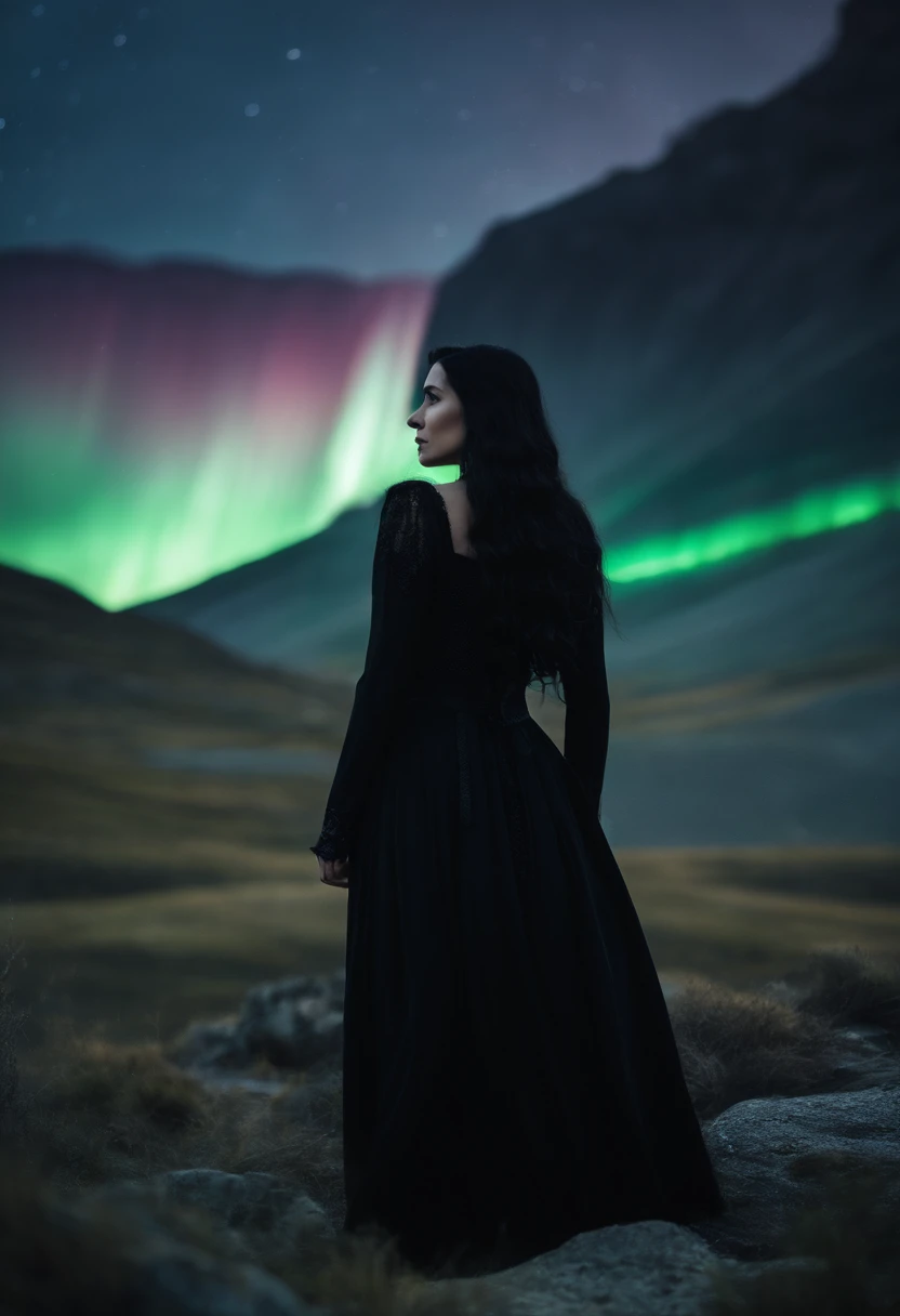 Straight black haired white young woman in gothic black clothes in mountains spot with aurora borealis