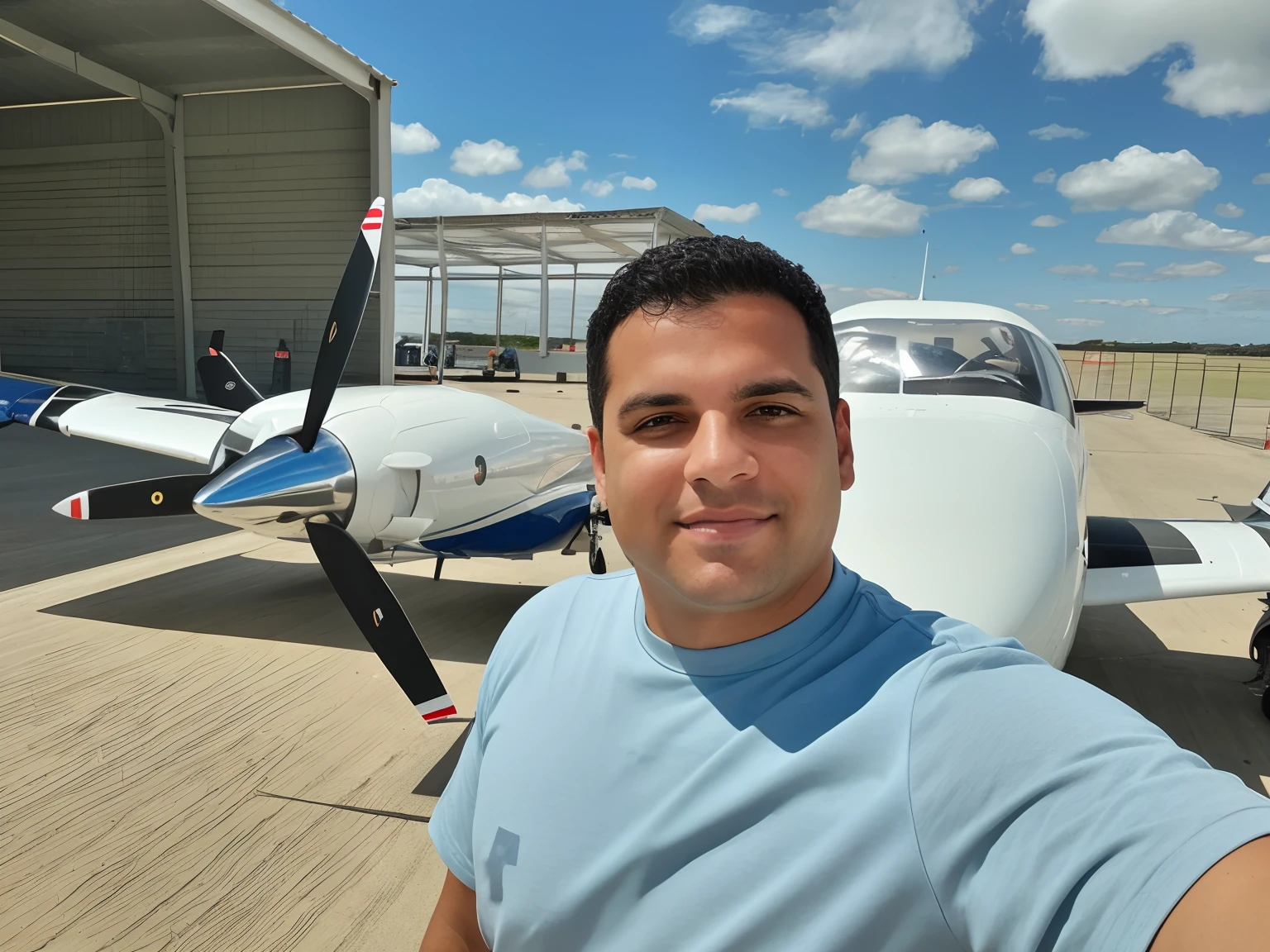 Arafed man standing in front of a small plane in a hangar, em pilotos, icaro carvalho, Tiro em GoPro9, selfie shot straight on angle, Assumido em Go Pro Hero8, Foto POV, imagem frontal, tirado no iphone 14 pro, Fotografia selfie 8k, selfie de um homem, tirado no iphone 1 3 pro