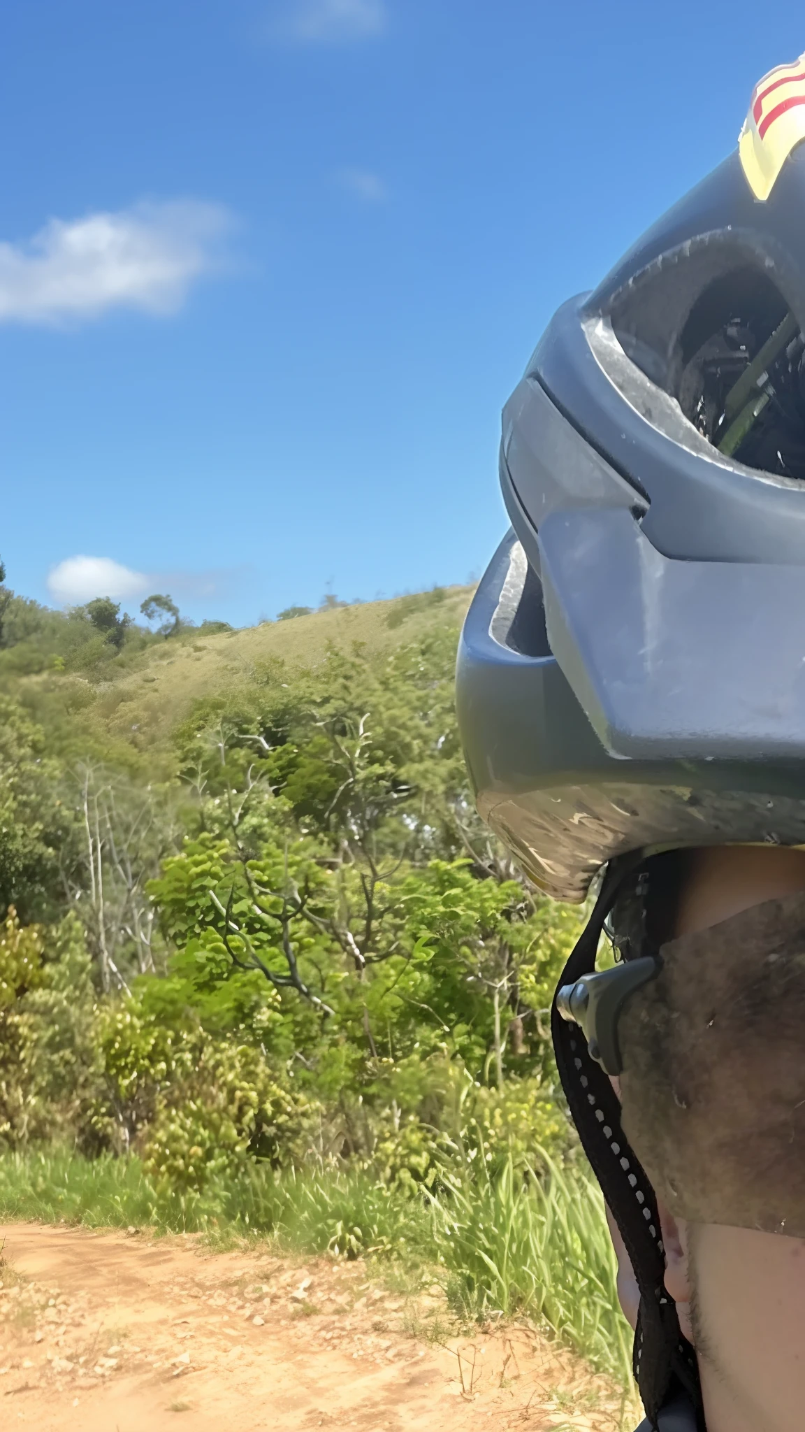 Man wearing helmet and goggles on dirt road, album photo, point of view of visor wearer, trabalho pioneiro suado e grosseiro, rosto suado, capacete de bicicleta de montanha, imagem de perfil, foto de perfil, Alma piedosa, vista do capacete, goggles on forehead, trying to ride it, tirado no iphone 14 pro, Ombros centrados para cima