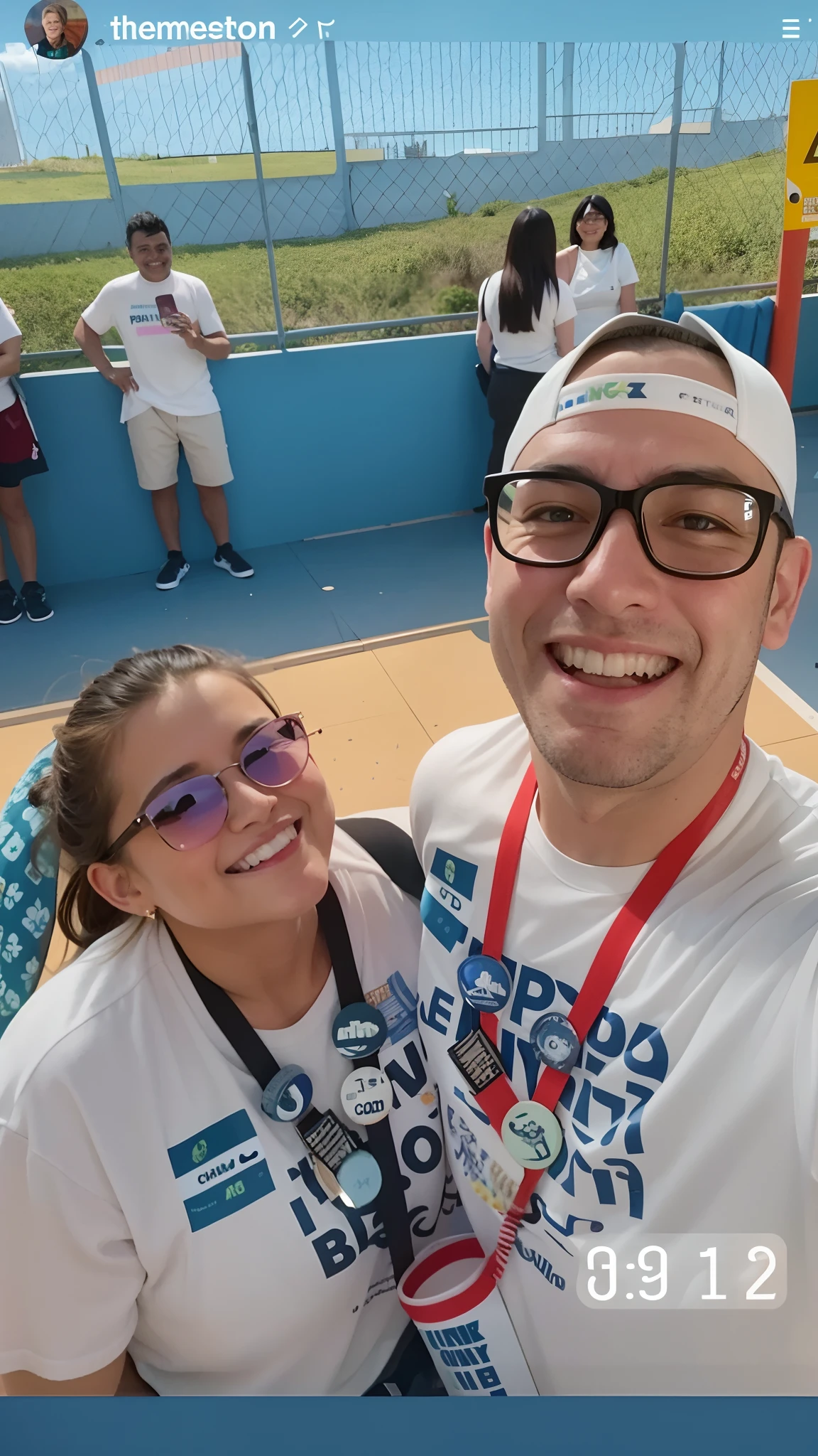 There are two people who are posing for a photo together, both smiling for the camera