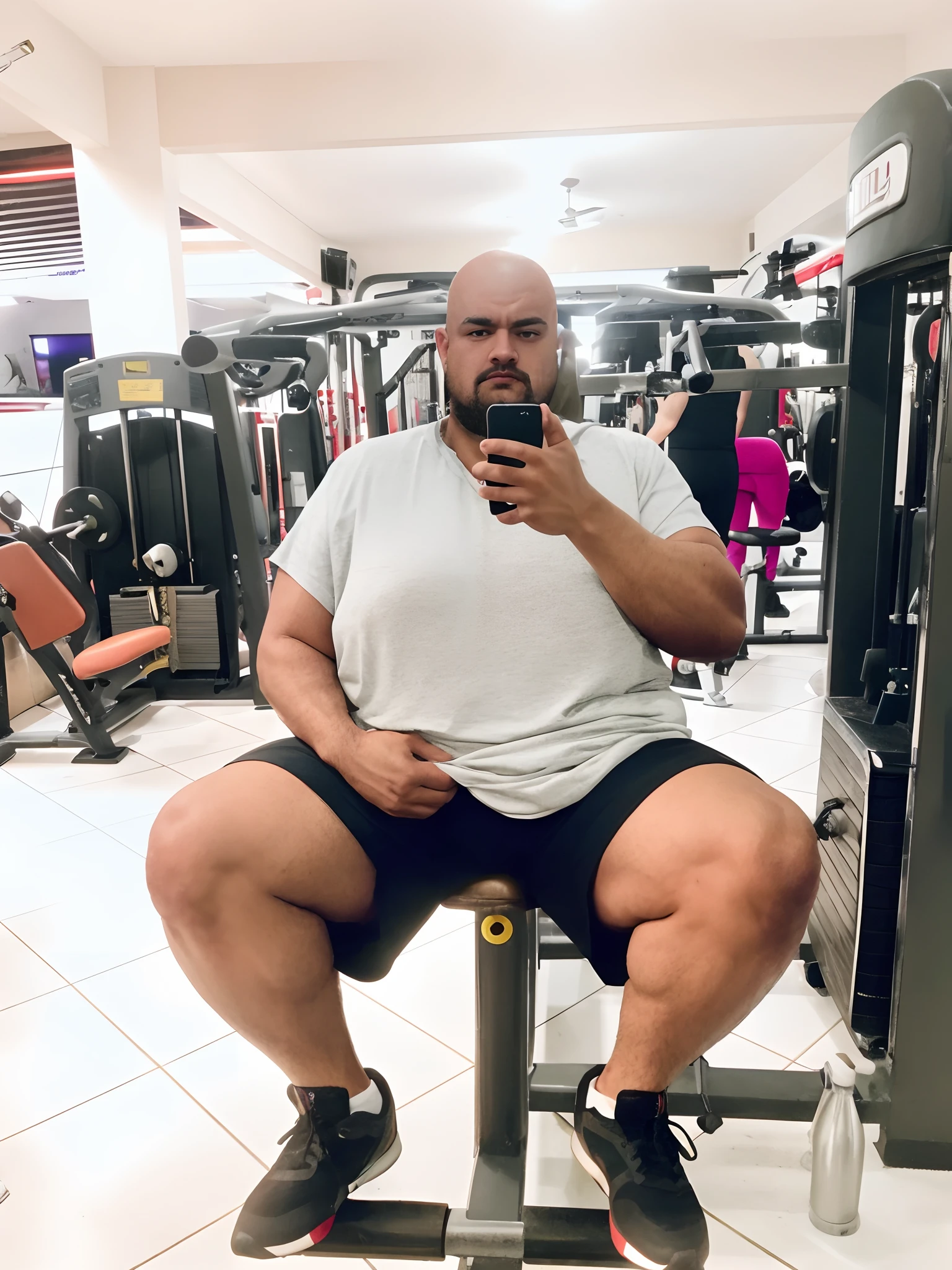 There's a man sitting on a bench in a gym, em uma academia, heavy appearance, encorpado, He's strong, He's chubby, muscular, He's bald with a mustache, barba a fazer, negro, encorpado, parrudo,  ele tem cerca de 28 anos de idade, ele tem cerca de 28 anos, coxas grandes, malhar