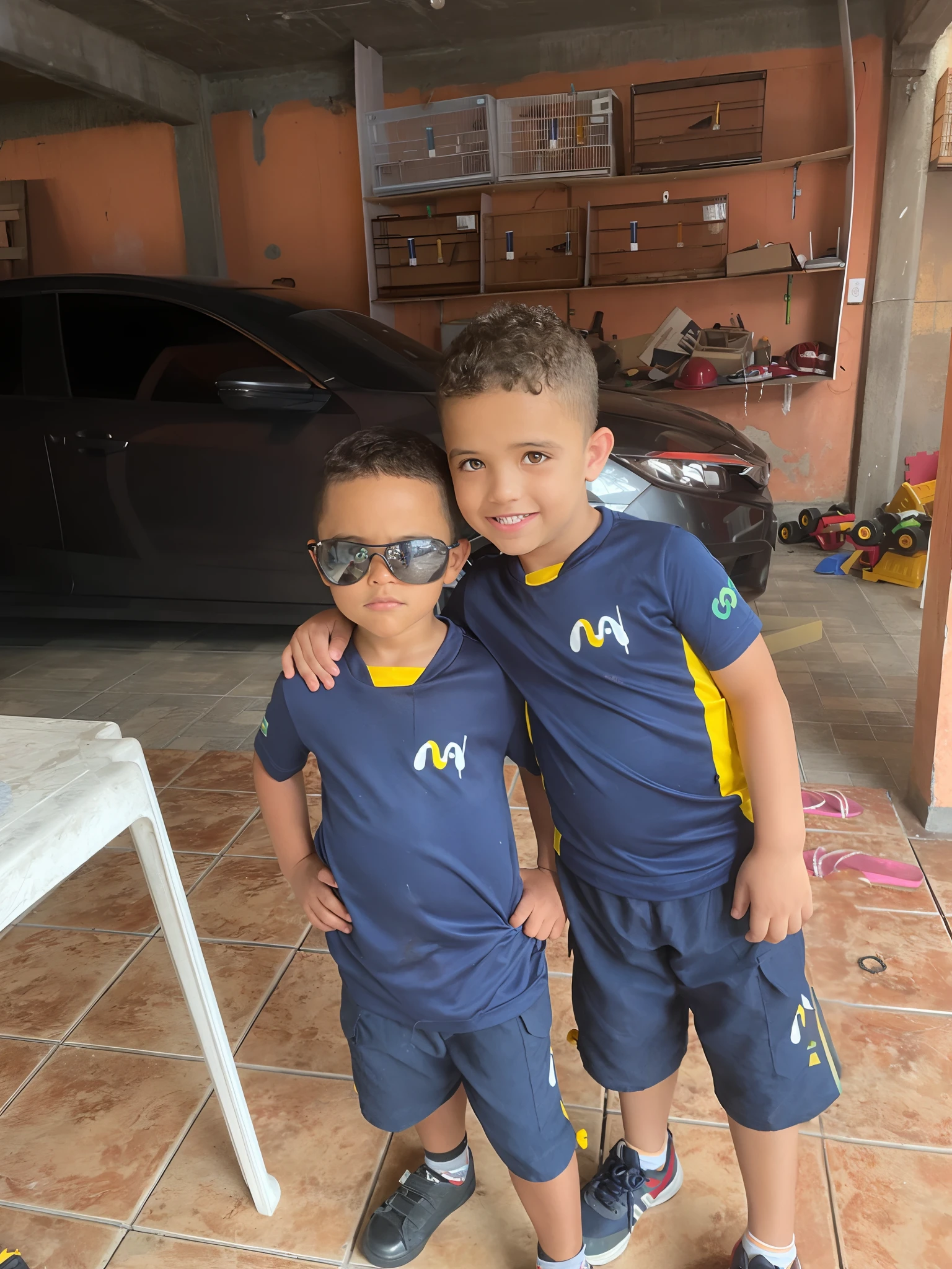 two young boys in matching blue shirts and sunglasses standing in a garage, ???, mateus 9 5, by Nándor Katona, boys, mohamed reda, ronaldo luis nazario da lima, by Emerson Silva, ronaldo nazario fenomeno, edon guraziu, wearing a school soccer uniform, cute boys, maher morcos, by Milton Menasco