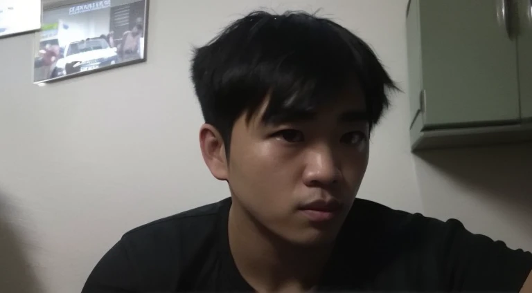 there is a man sitting in a kitchen with a remote control, captured with sony a3 camera, 2 7 years old, around 1 9 years old, face picture, 2 8 years old, with serious face expression, south east asian with round face, 2 3 years old, front profile!!!!, 2 9 years old, very very low quality picture, kentaro