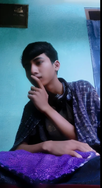 there is a man sitting on a bed with a purple blanket, ayan nag, around 1 9 years old, picture, old picture, with lovely look, reyyan, very very low quality picture, roshan, ismail, candid picture, raden saleh, with accurate face, candid photo, with a cool pose, riyahd cassiem, large)}]