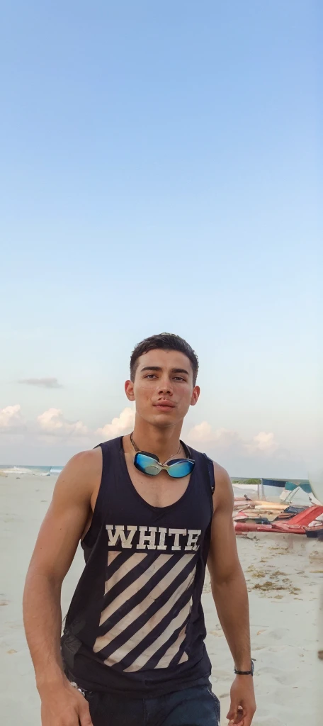 Portrait of a handsome male model in a beach, 18 ans, Barechest, sans barbe, with short wavy hair, yeux bleus, thick lips