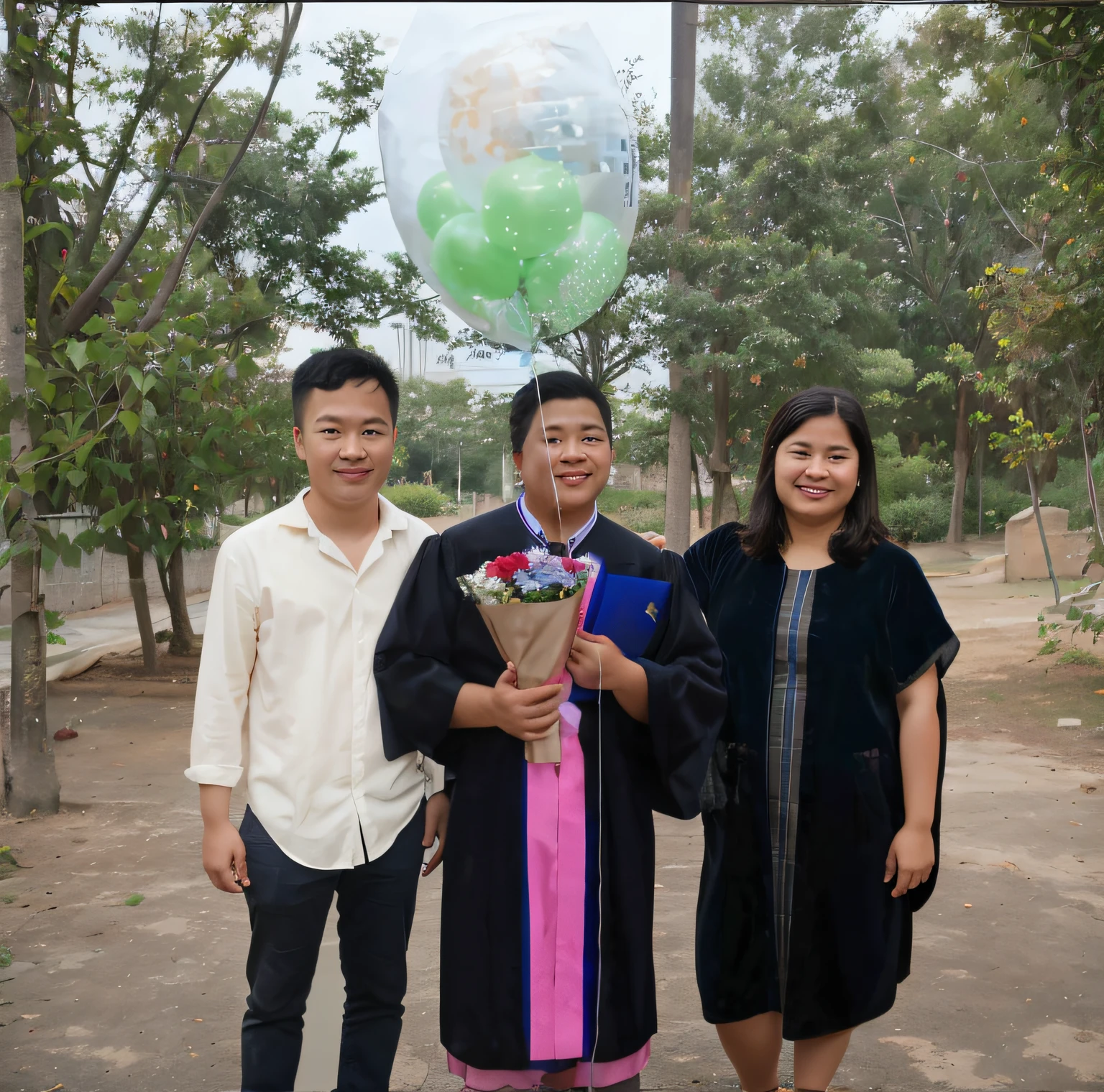 there are three people standing together holding a bouquet and a balloon, graduation photo, photo taken in 2 0 2 0, post graduate, photo taken with nikon d 7 5 0, photo taken with nikon d750, wearing an academic gown, taken with canon 8 0 d, photoshot, husband wife and son, taken with sony alpha 9, exclusive