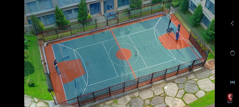 A basketball court behind a school