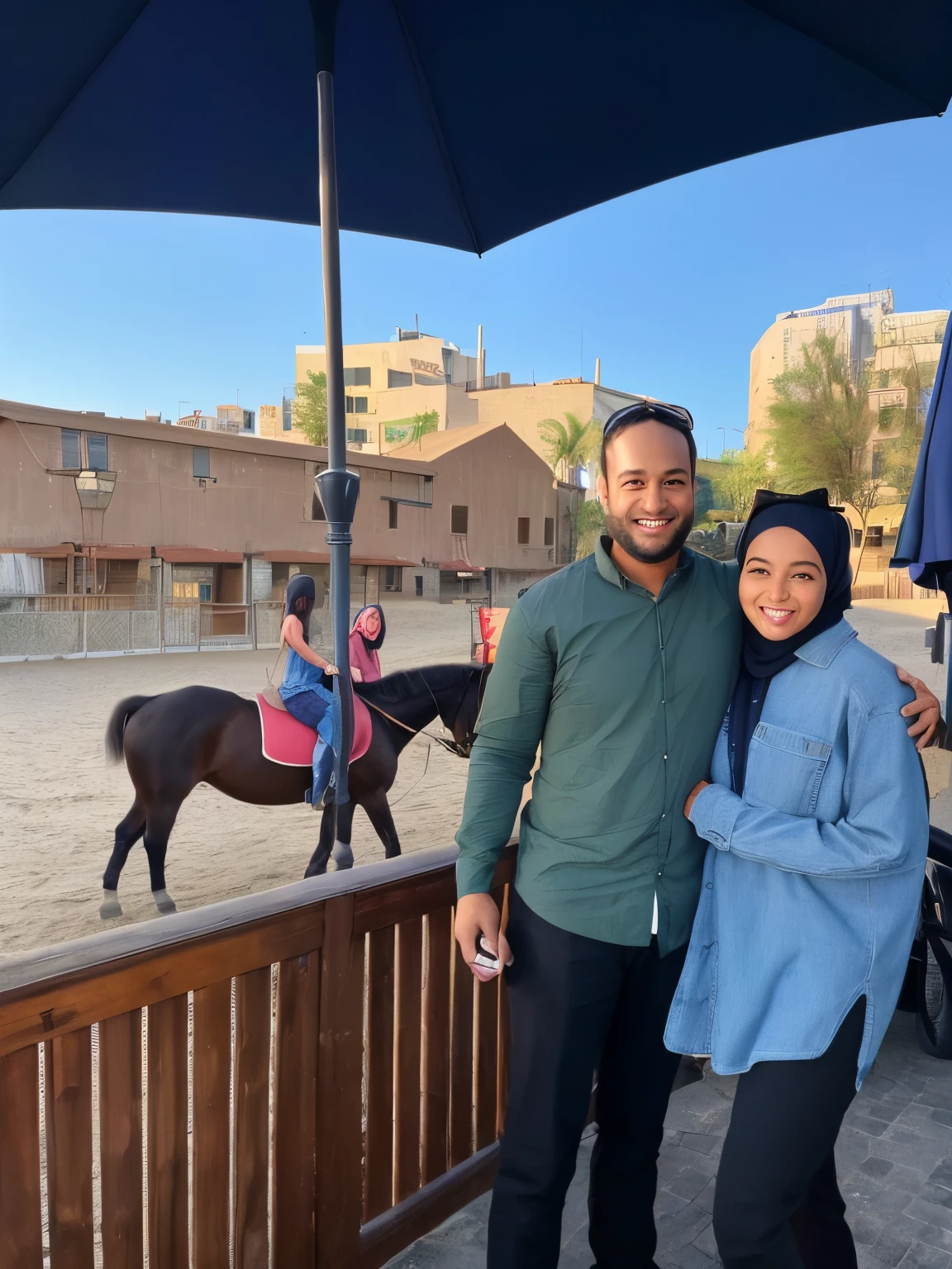 A smiling man wearing a green shirt and light brown hair, and a smiling woman wearing a blue shirt and a black hijab. they are standing under an umbrella on a patio with a horse, with horse driven, on a horse, taken on iphone 14 pro, by Romain brook, horse in background, taken on iphone 1 3 pro, by Meredith Dillman, 🤬 🤮 💕 🎀, shot on iphone 1 3 pro, riding a horse!!! in saharan, artist unknown