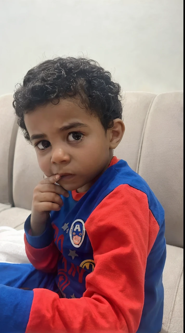 there is a young boy sitting on a couch with a toothbrush in his mouth, riyahd cassiem, mohamed reda, 2 years old, reyyan, mohamed chahin, young boy, young child, ismail, ayan nag, cute boy, atef, serious expression, inspired by Fathi Hassan, thoughtful expression, four years old, serious look