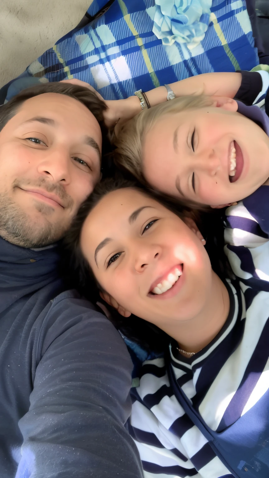 there are three people laying on a blanket together on the ground, profile image, profile pic, husband wife and son, profile picture, profile photo, happy family, having a great time, having a good time, family friendly, a picture, portrait of family of three, niele toroni, mixed art, family photo, photo portrait, shot on iphone 1 3 pro
